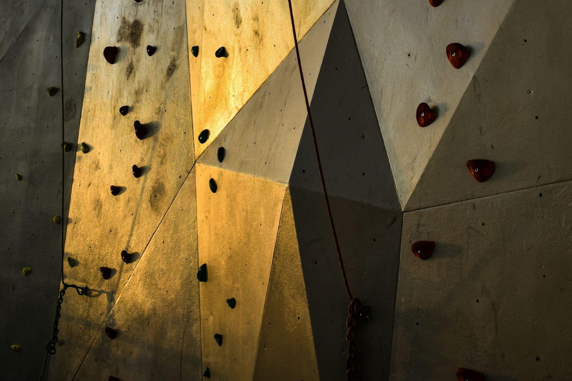 Indoor climbing wall with holds and climbing ropes