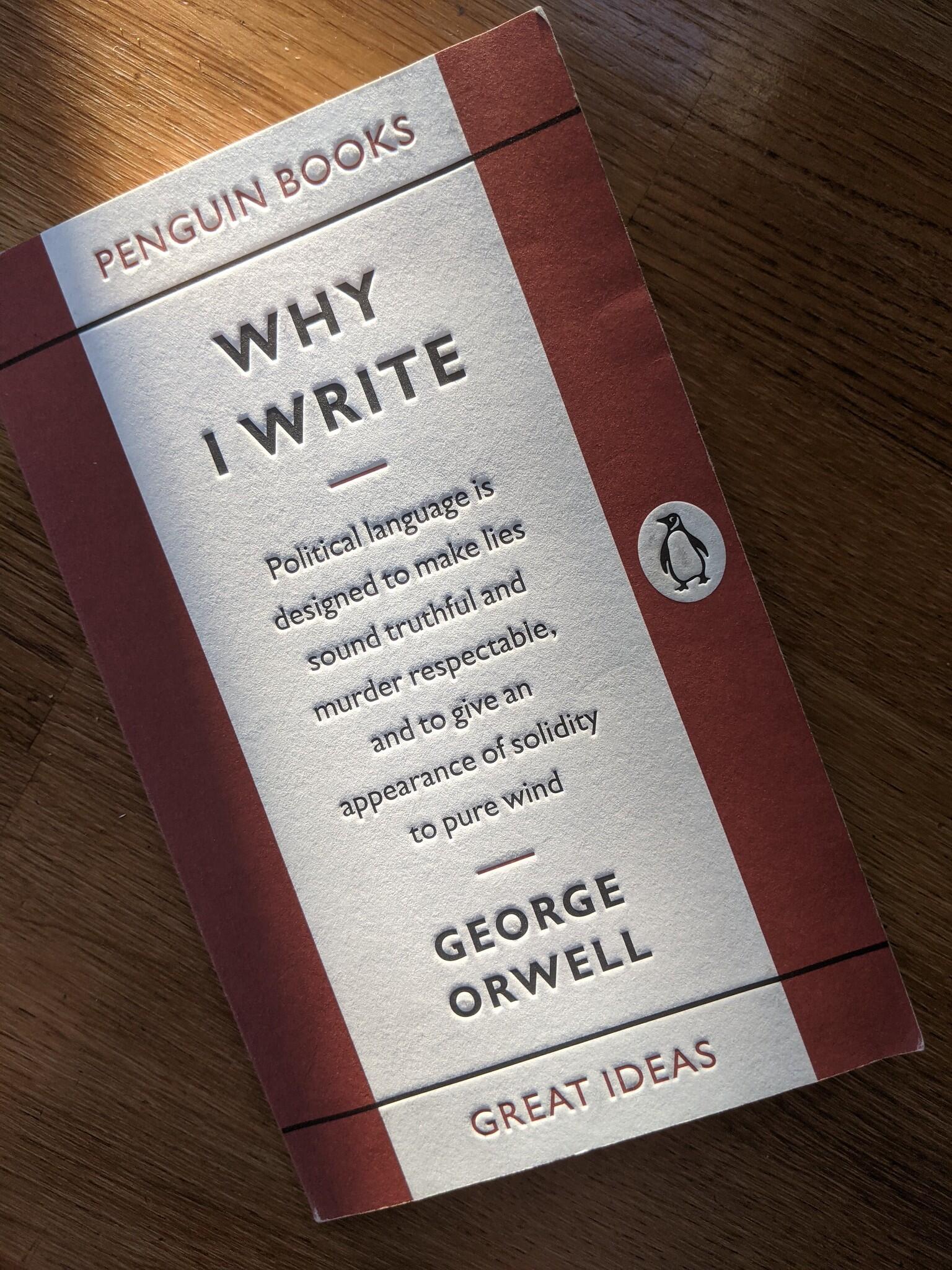 George Orwell’s Penguin Books booklet Why I Write lies diagonally on a wooden table, with the subtitle “Great Ideas” visible on the cover.