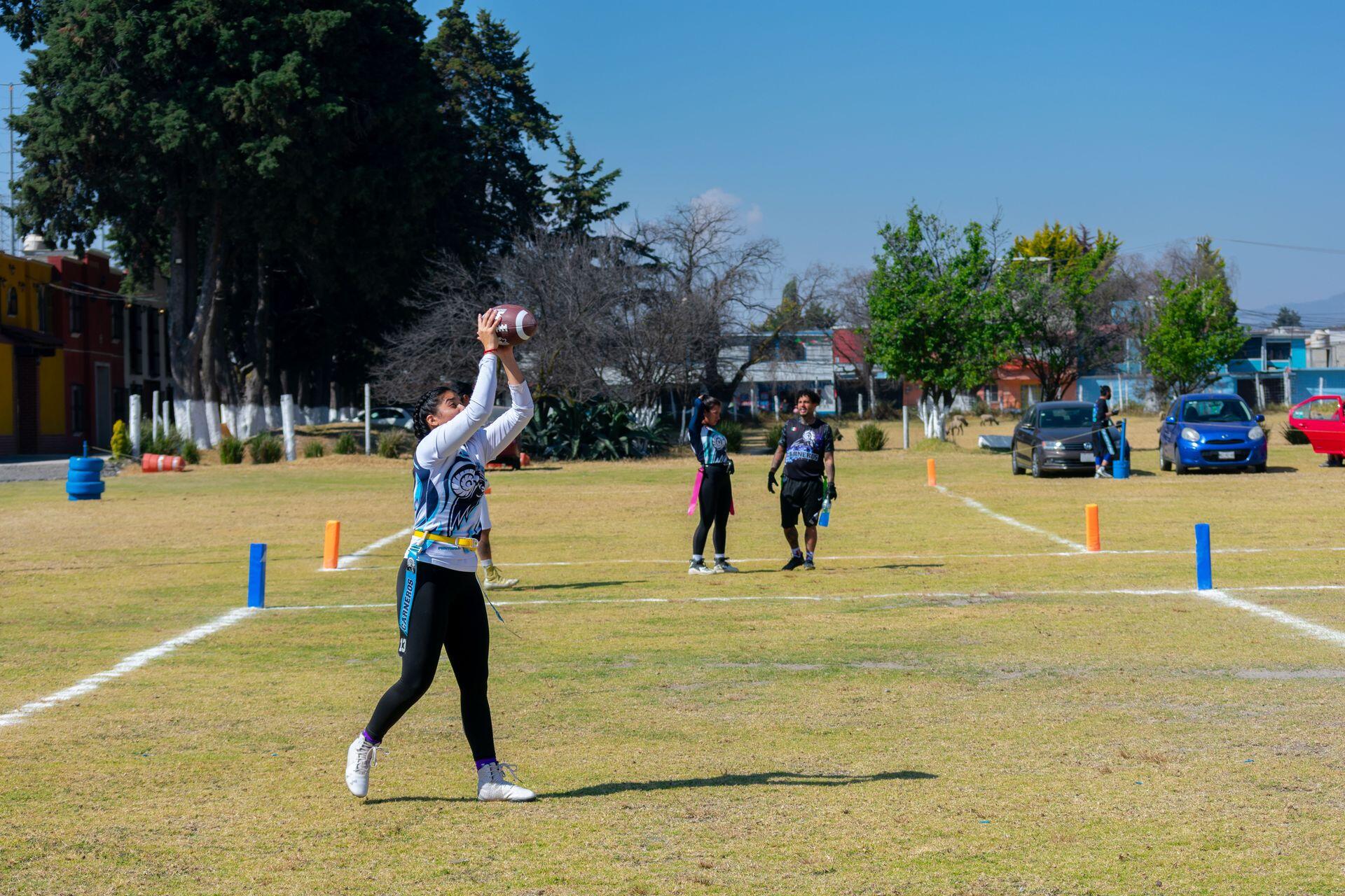 Flag football player receiving a ball.