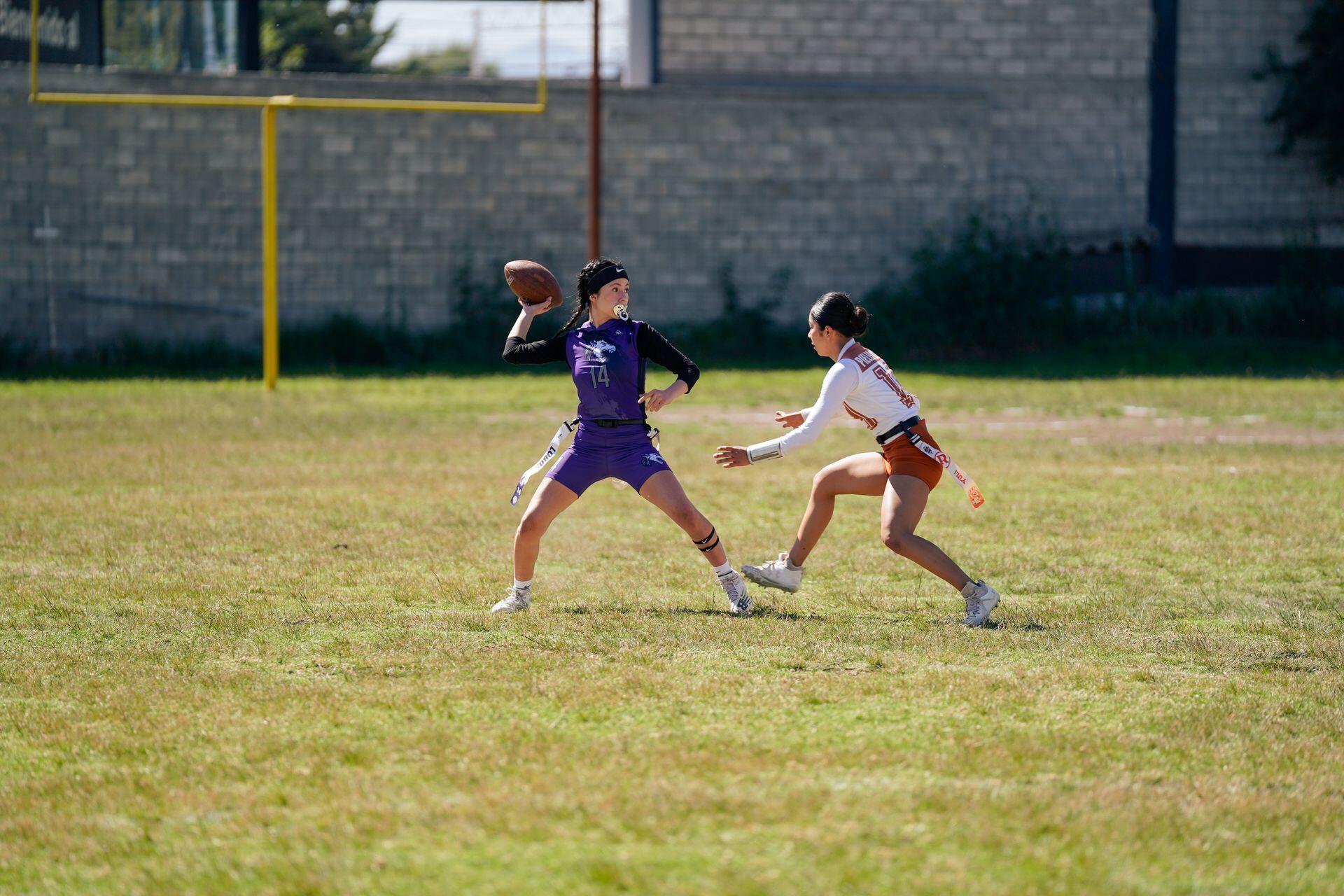 Two flag football athletes competing against each other.