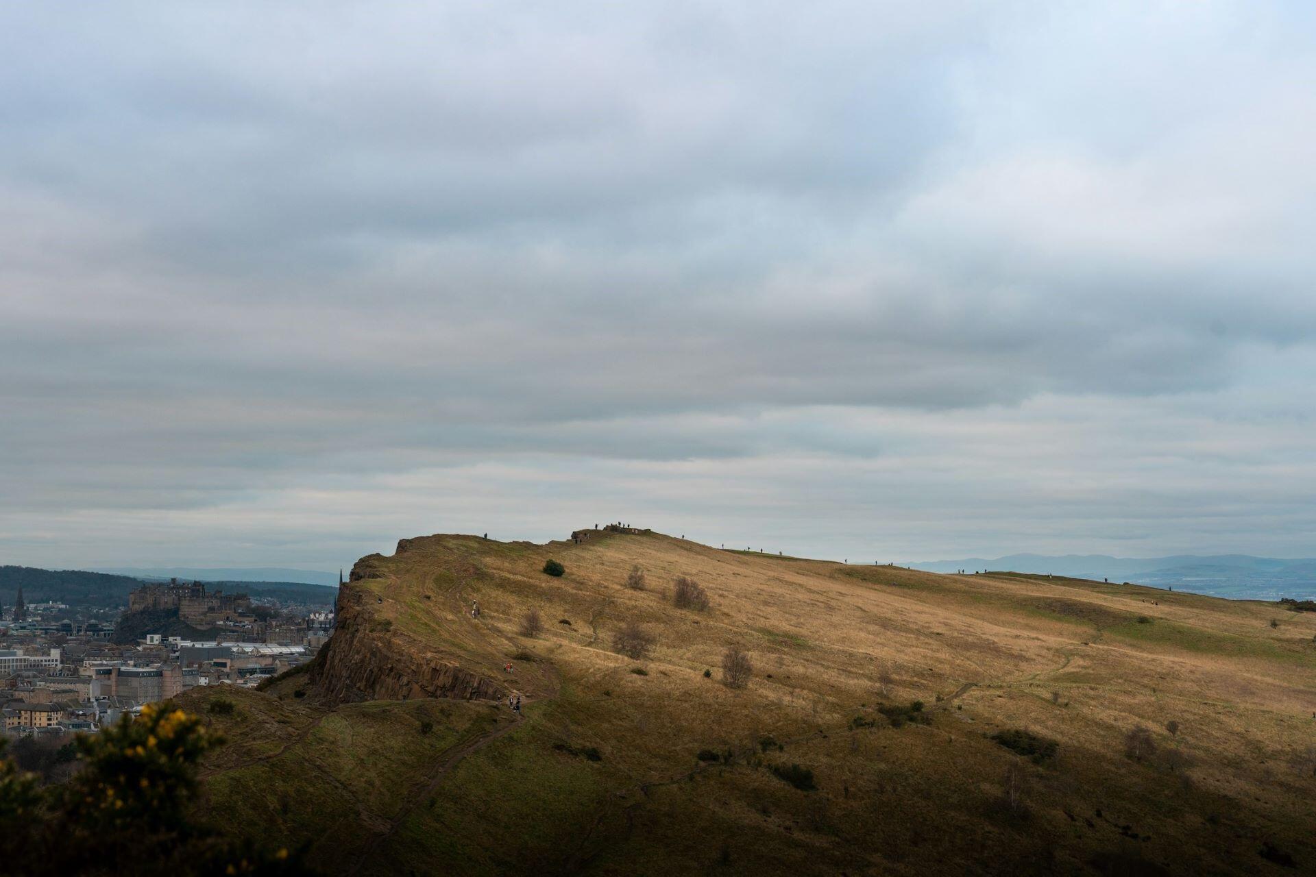 Salisbury Crags overlooking Edinburgh under cloudy skies