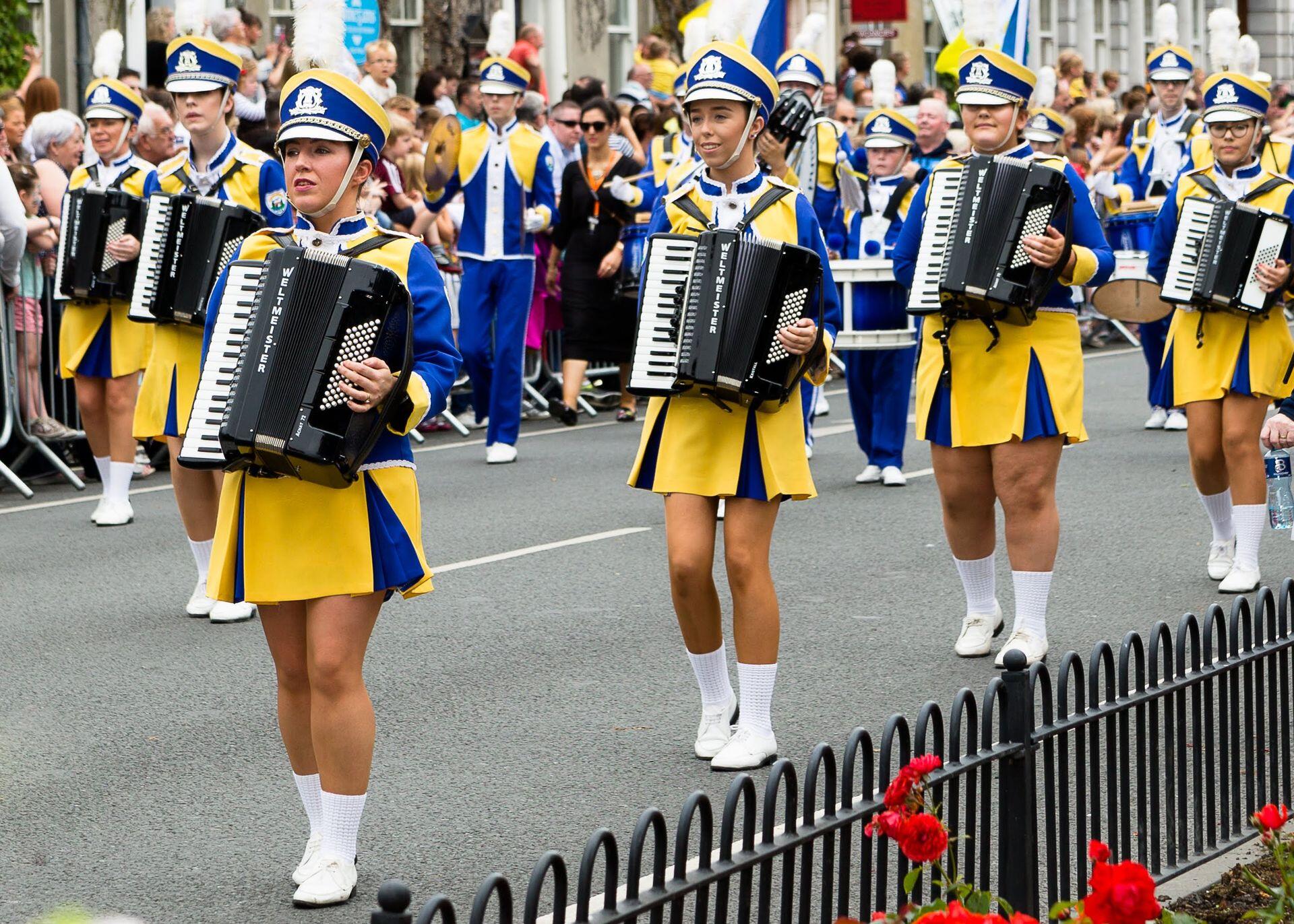 marching band players in uniform playing accordions