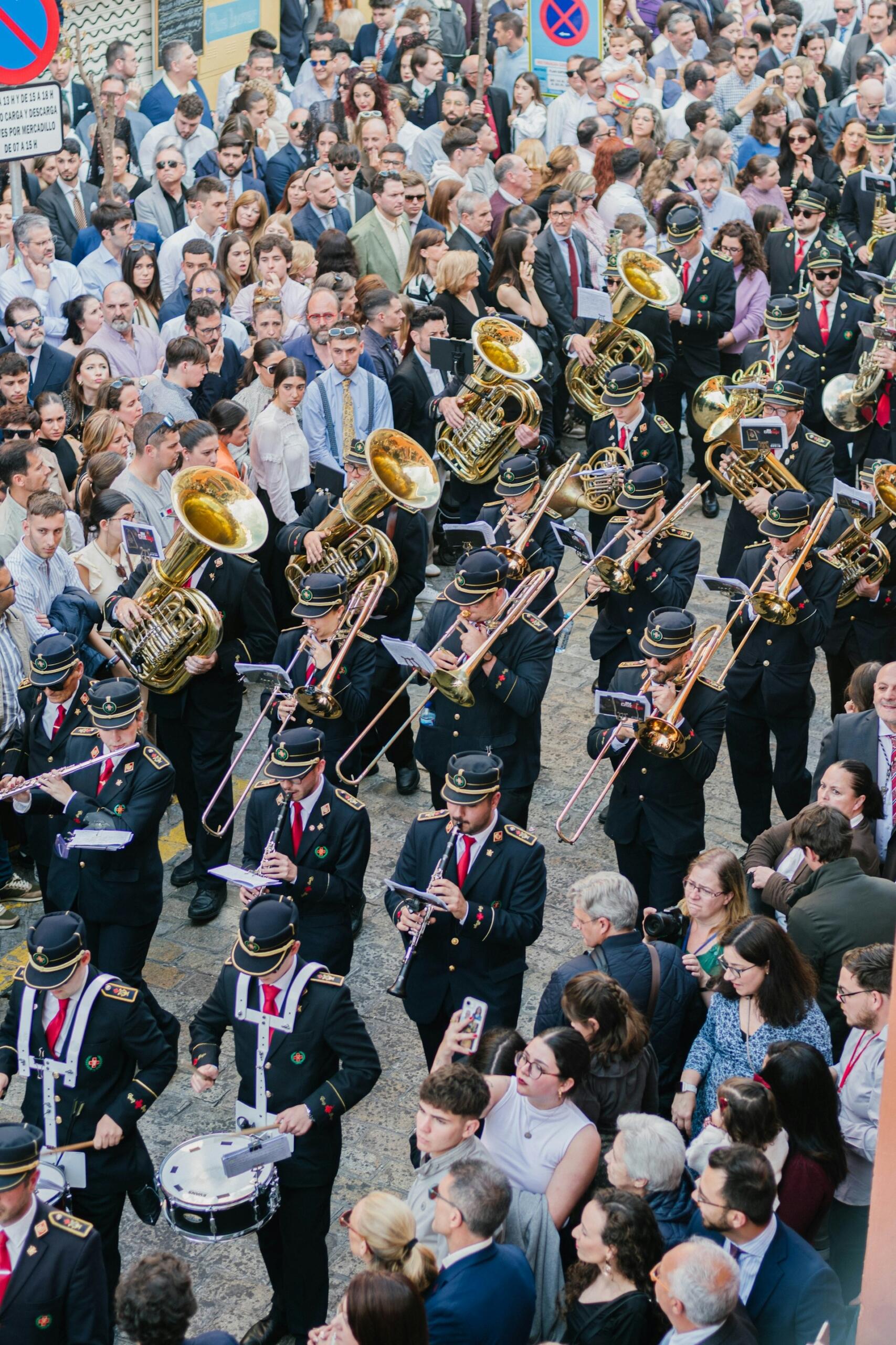 trombone and euphonium players in a marching band, marching in uniform and formation in a parade