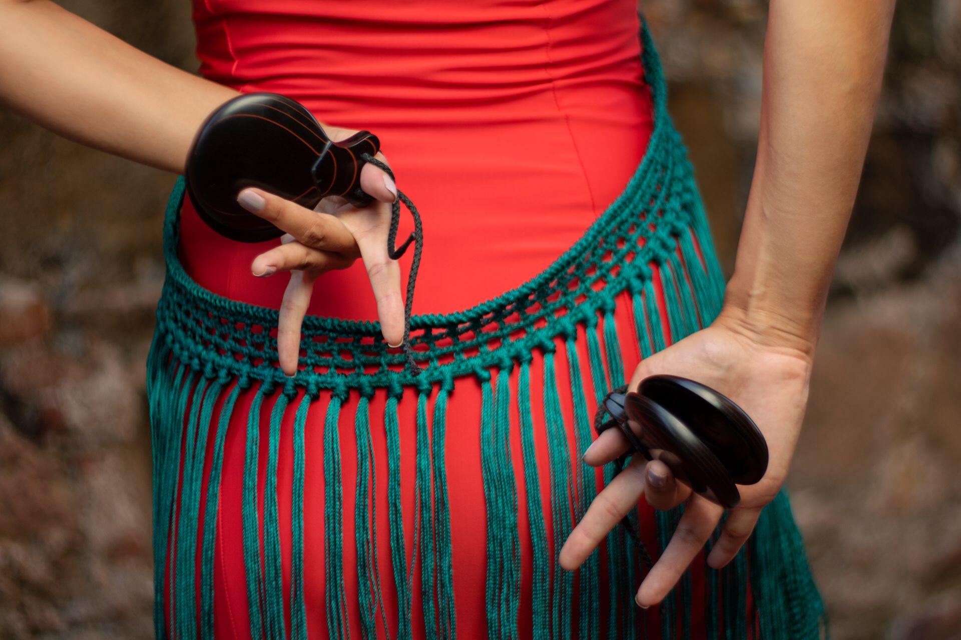 dancer holding traditional castanets behind their back for a dance