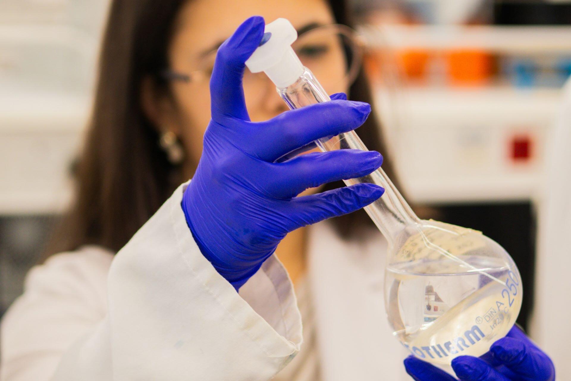 Scientist holding a glass flask in a laboratory