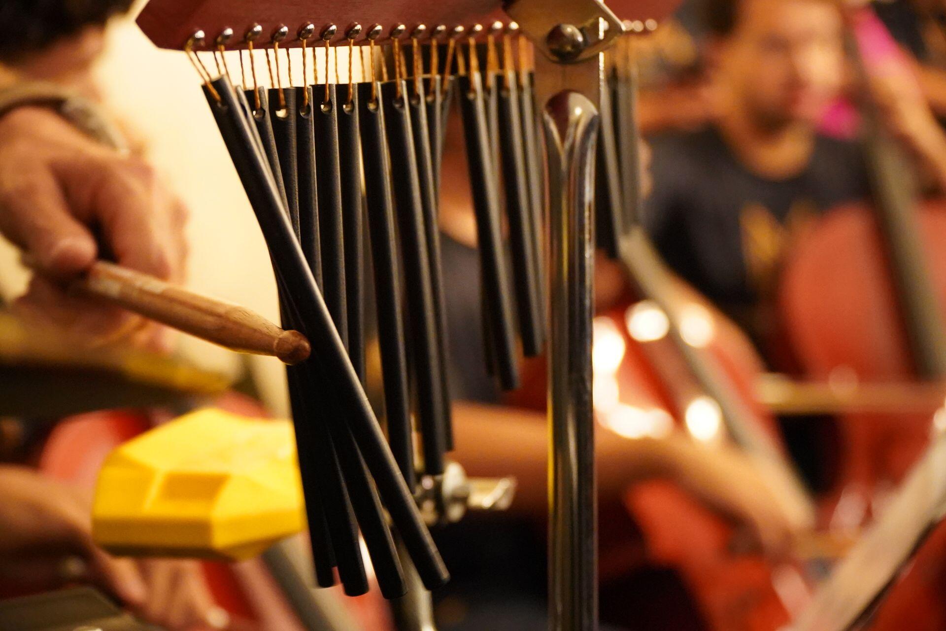 set of chimes being struck by a drumstick