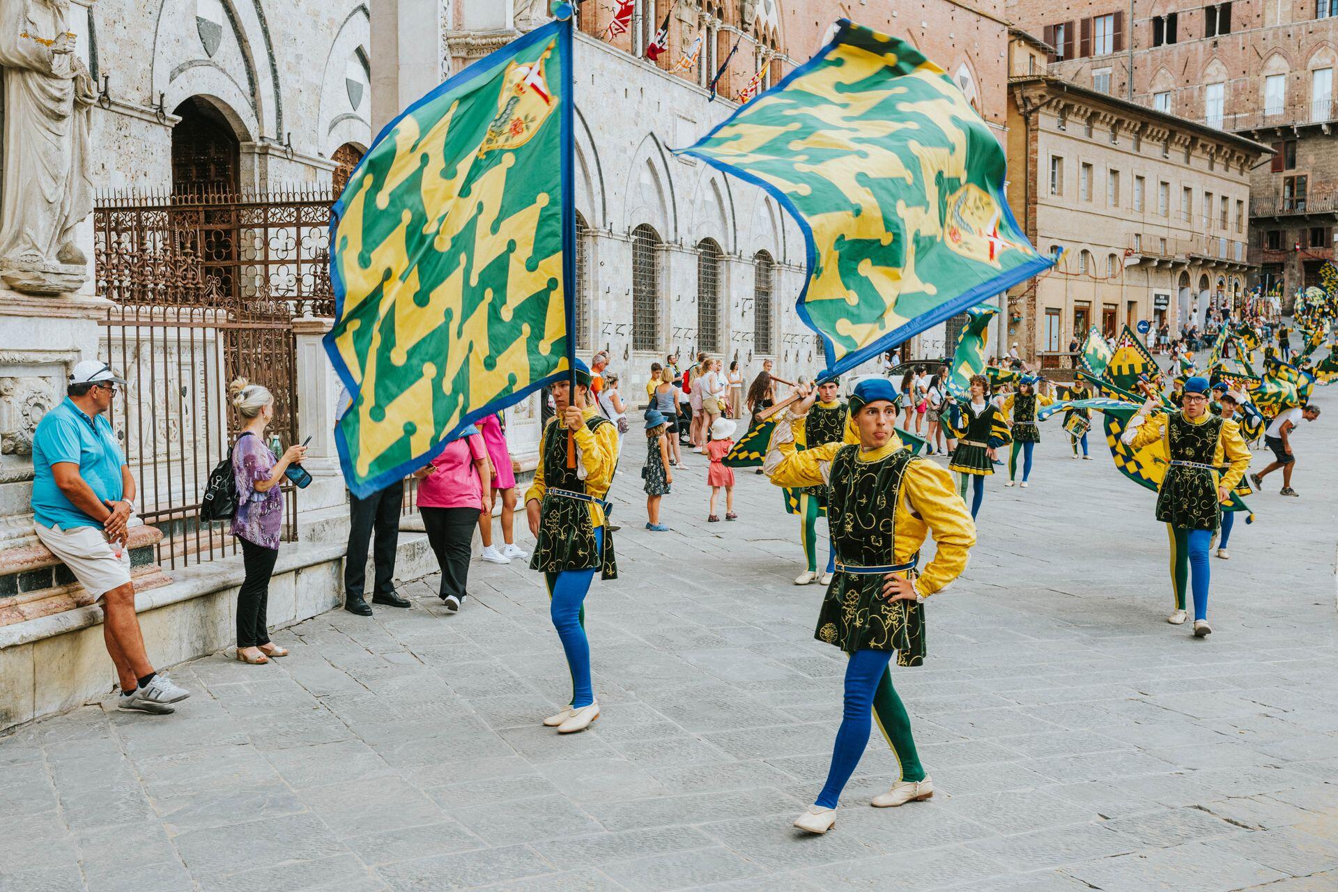 flag twirling colour guard members in a parade