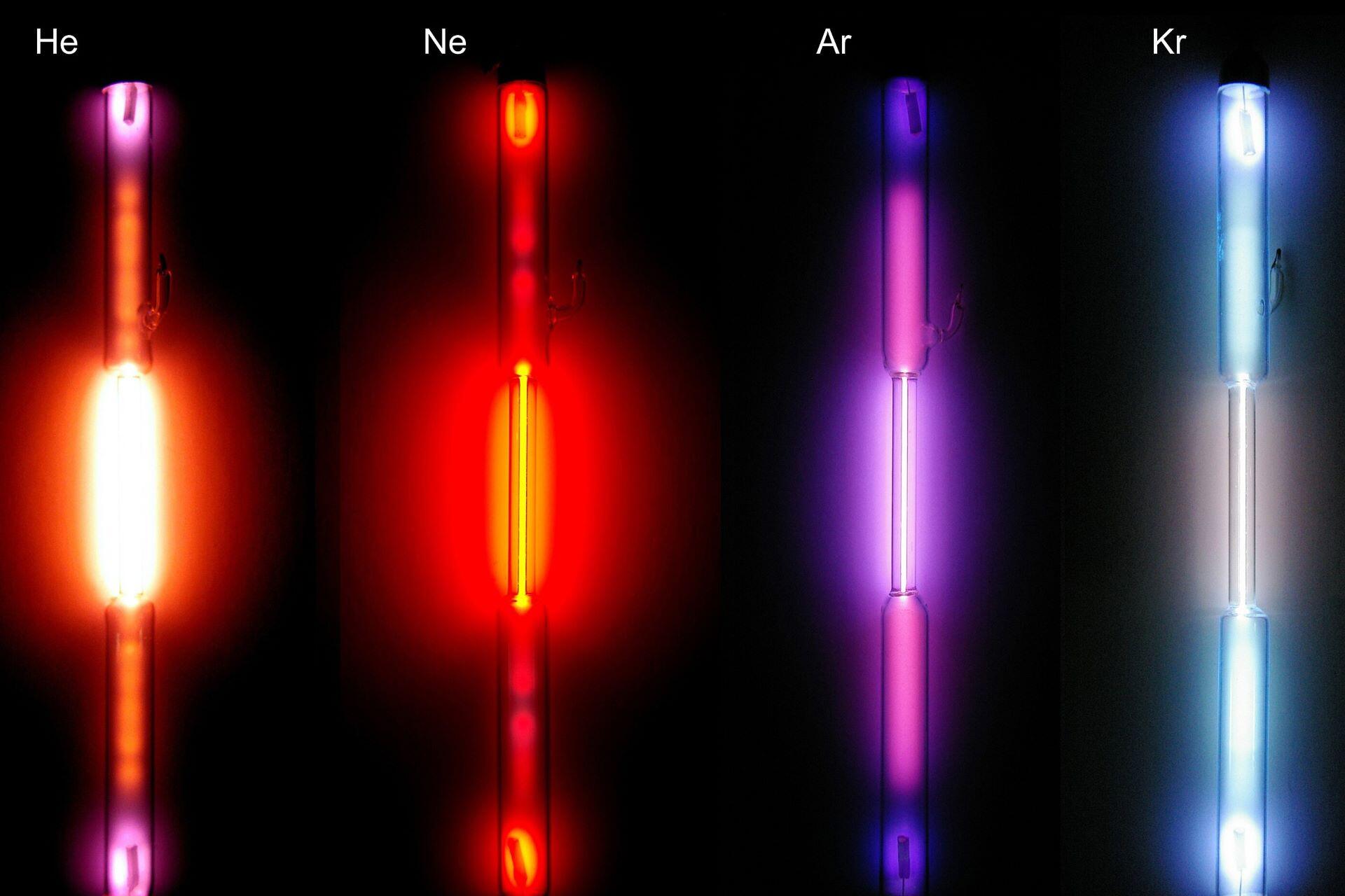 Helium, neon, argon and krypton glowing in labelled gas-discharge tubes.