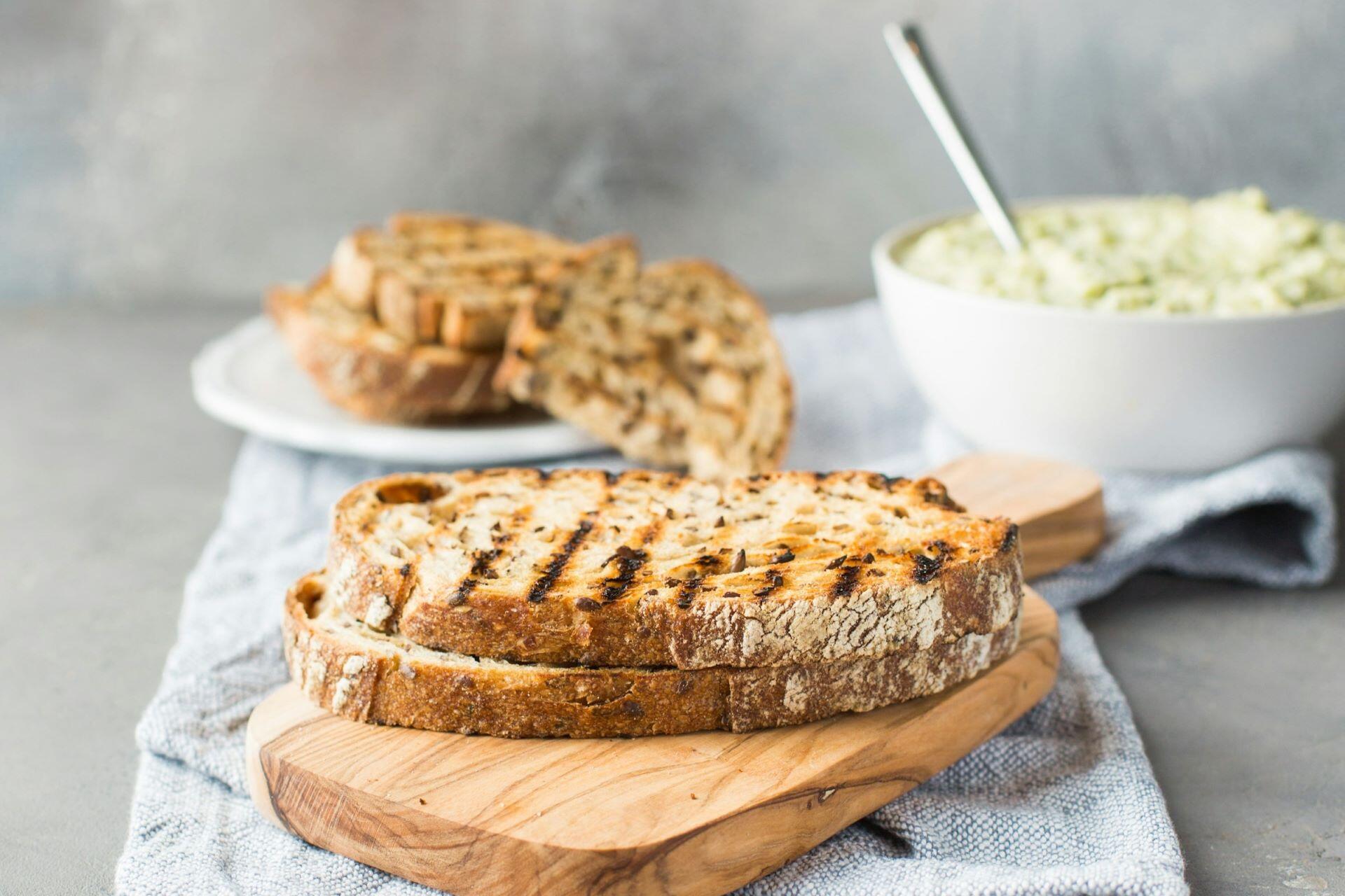 Slices of toasted bread on a wooden board