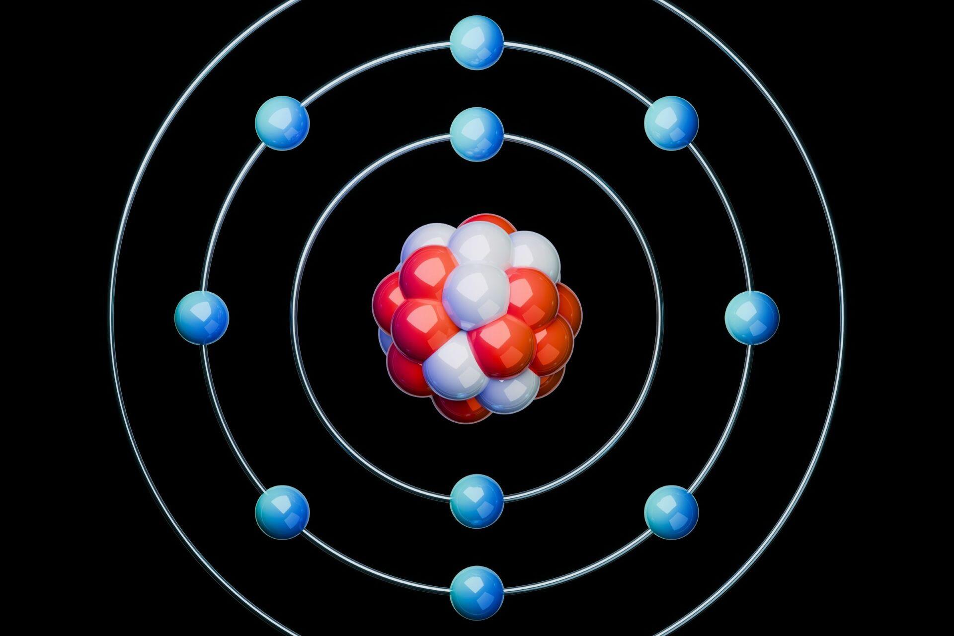 Atomic model with blue electrons orbiting a red and white nucleus