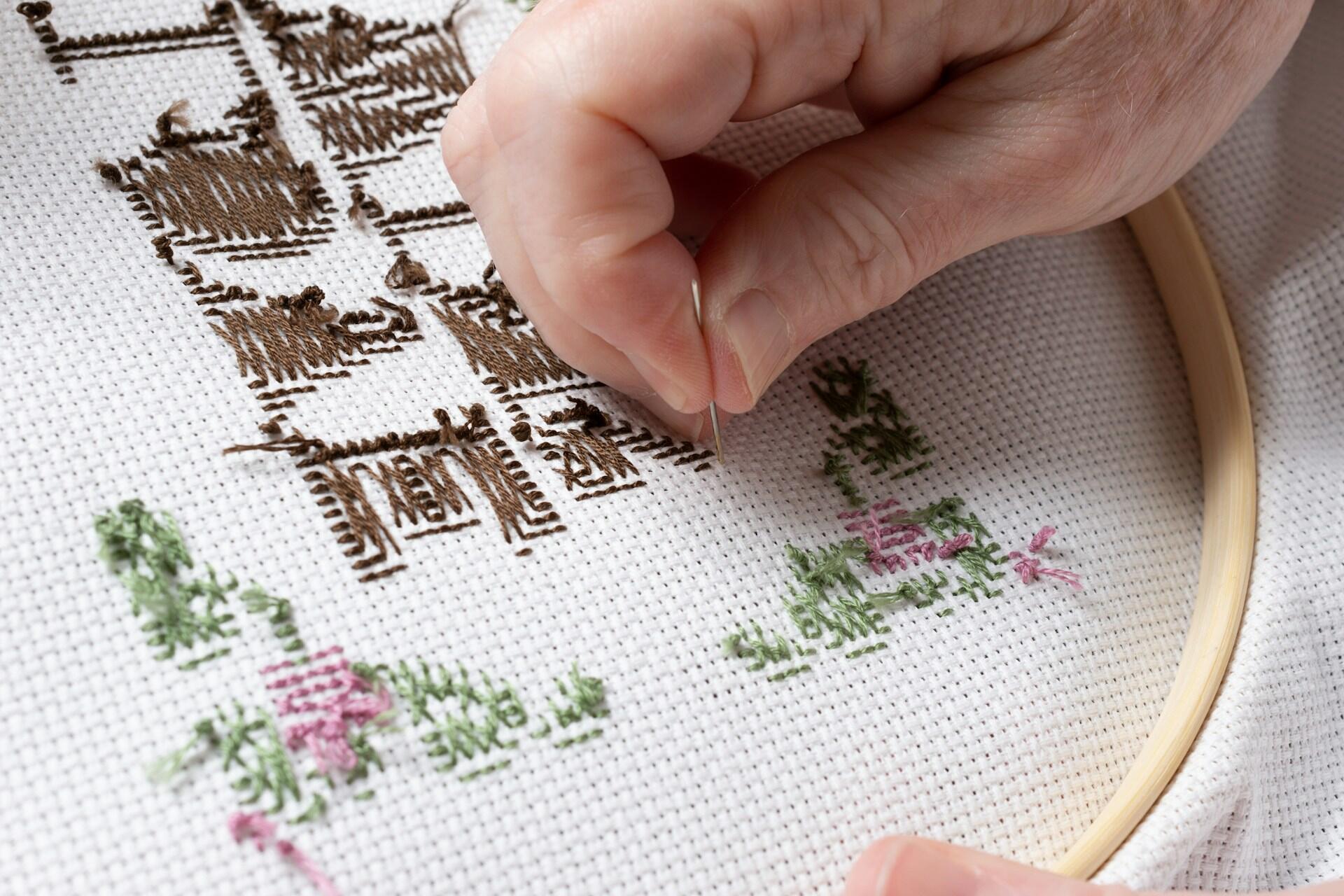 A close-up of somebody doing embroidery.