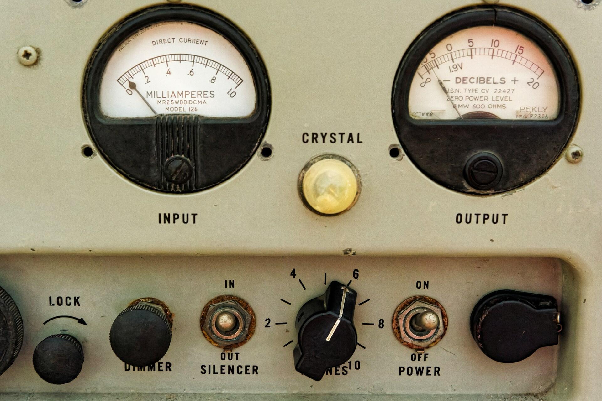 A machine measuring amps and decibels.