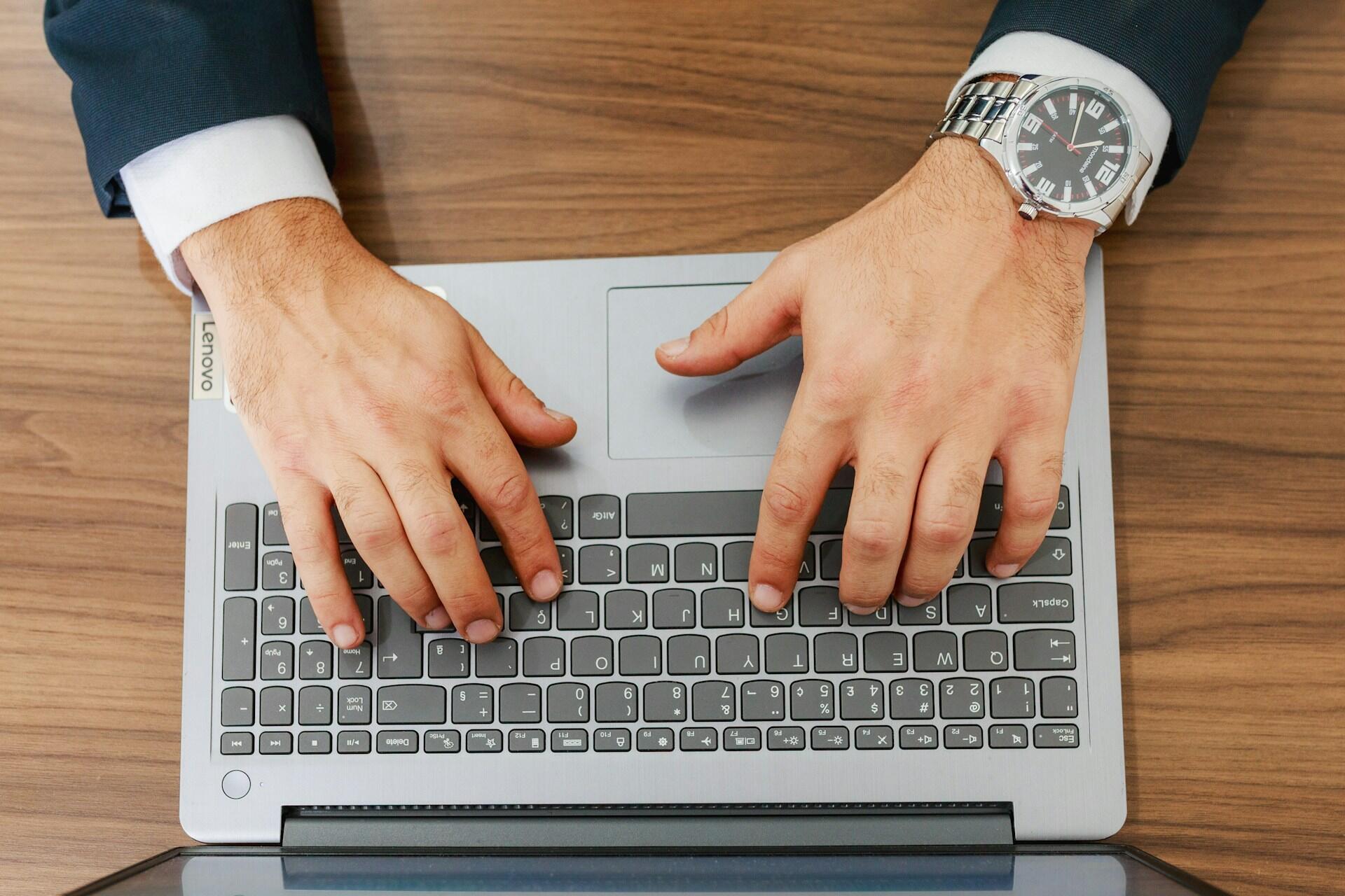 A lawyer typing on a laptop.