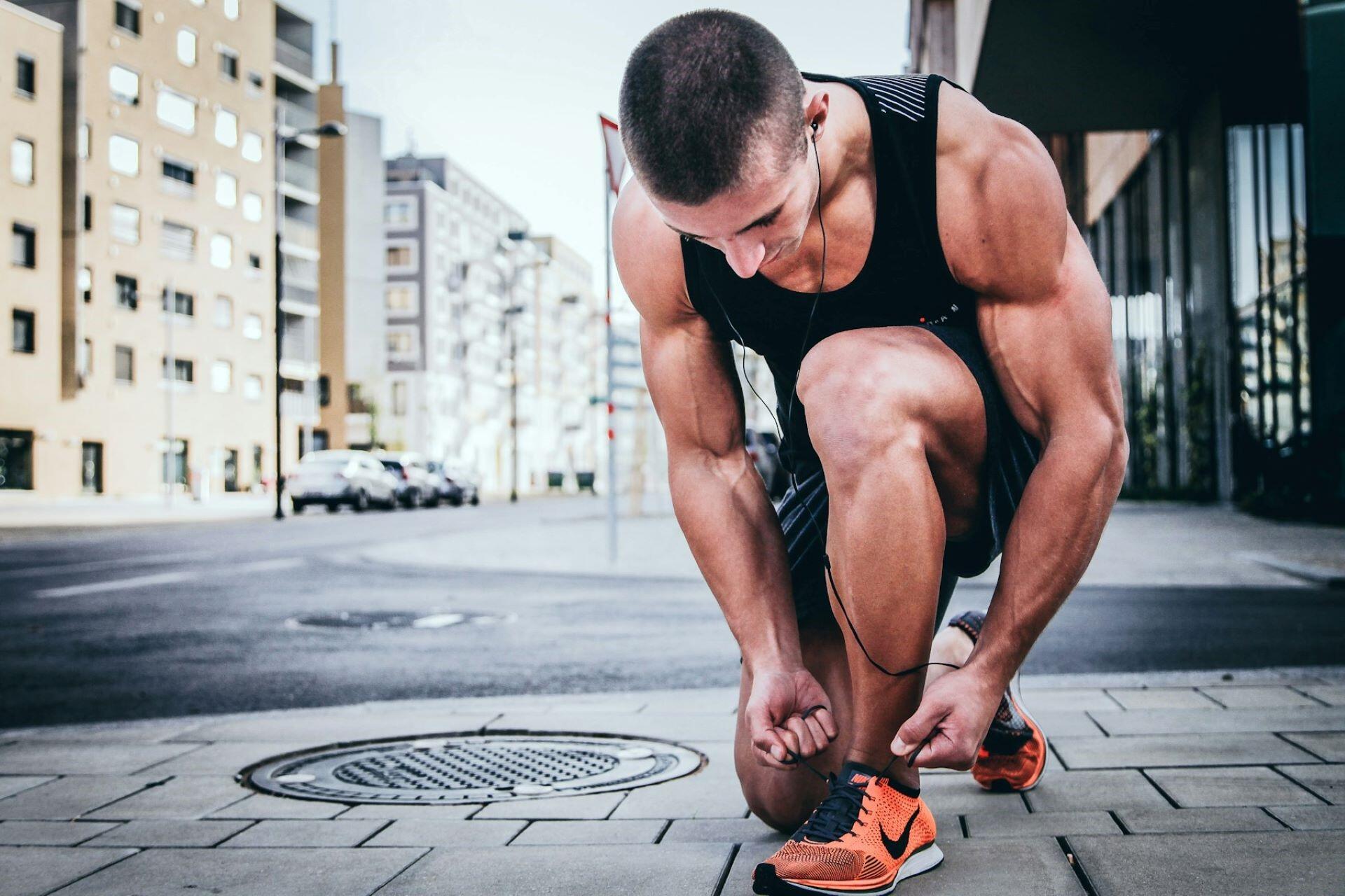 A runner tying their laces.