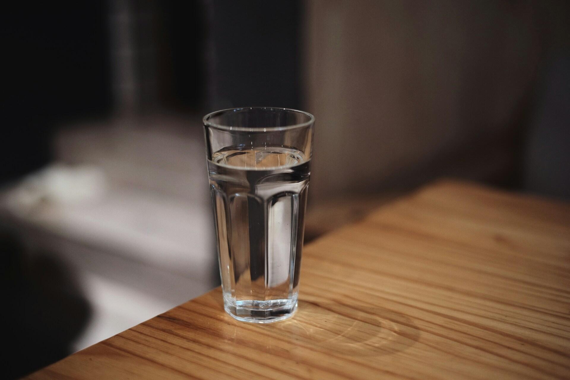 A glass of water on a table.