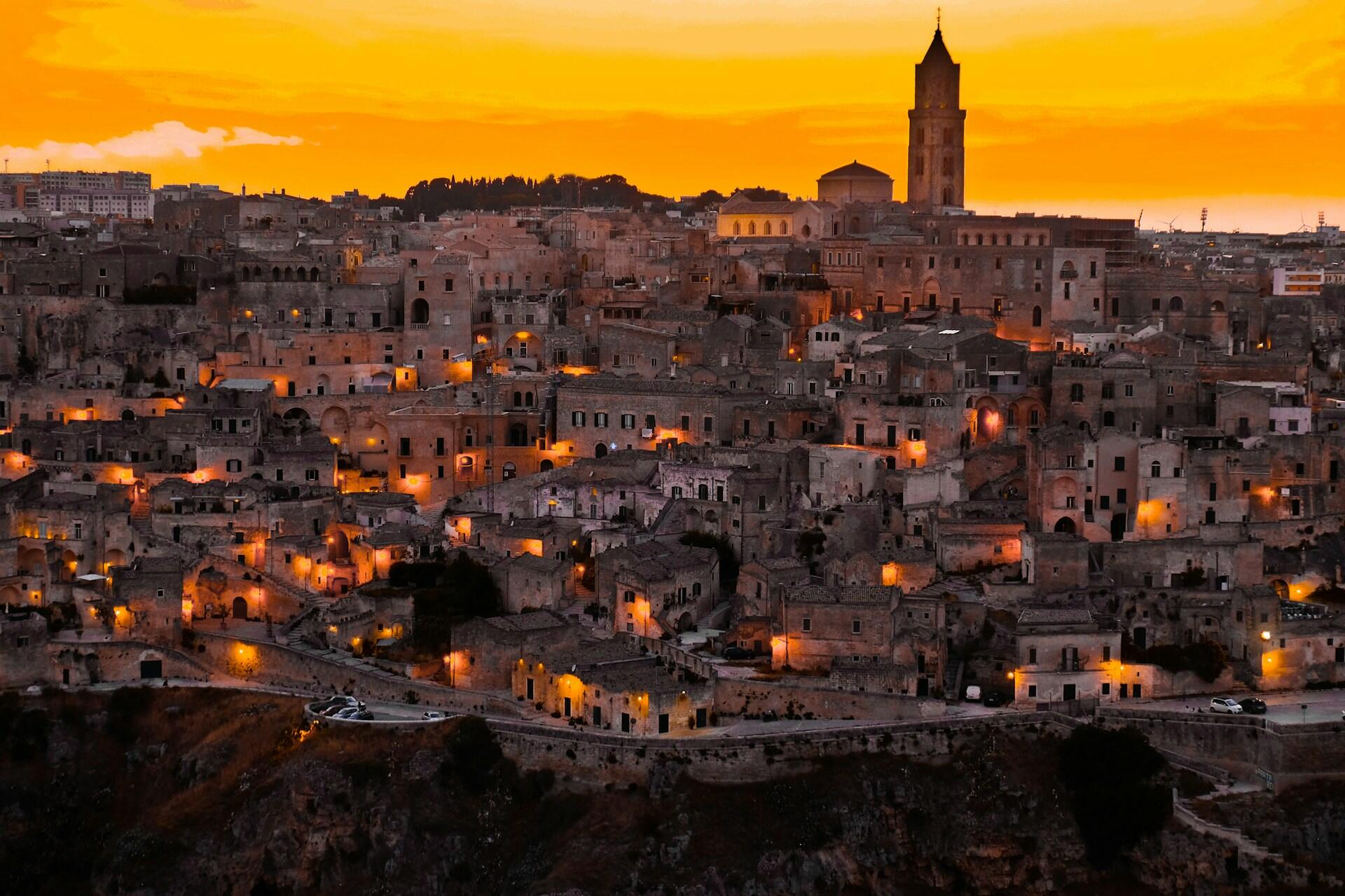 View across the historic stone buildings of Matera, Italy, at sunset