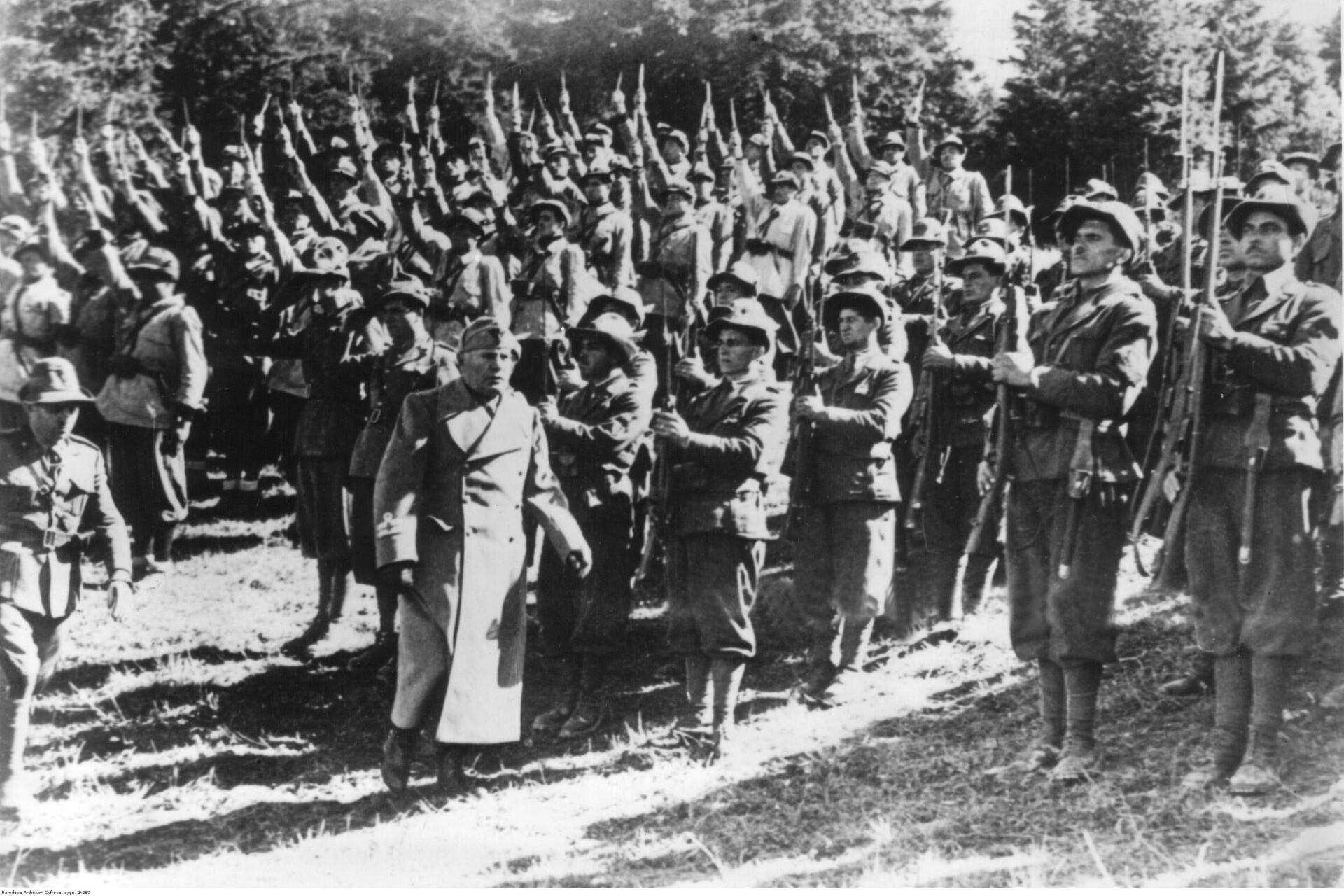 Benito Mussolini in front of Italian troops.
