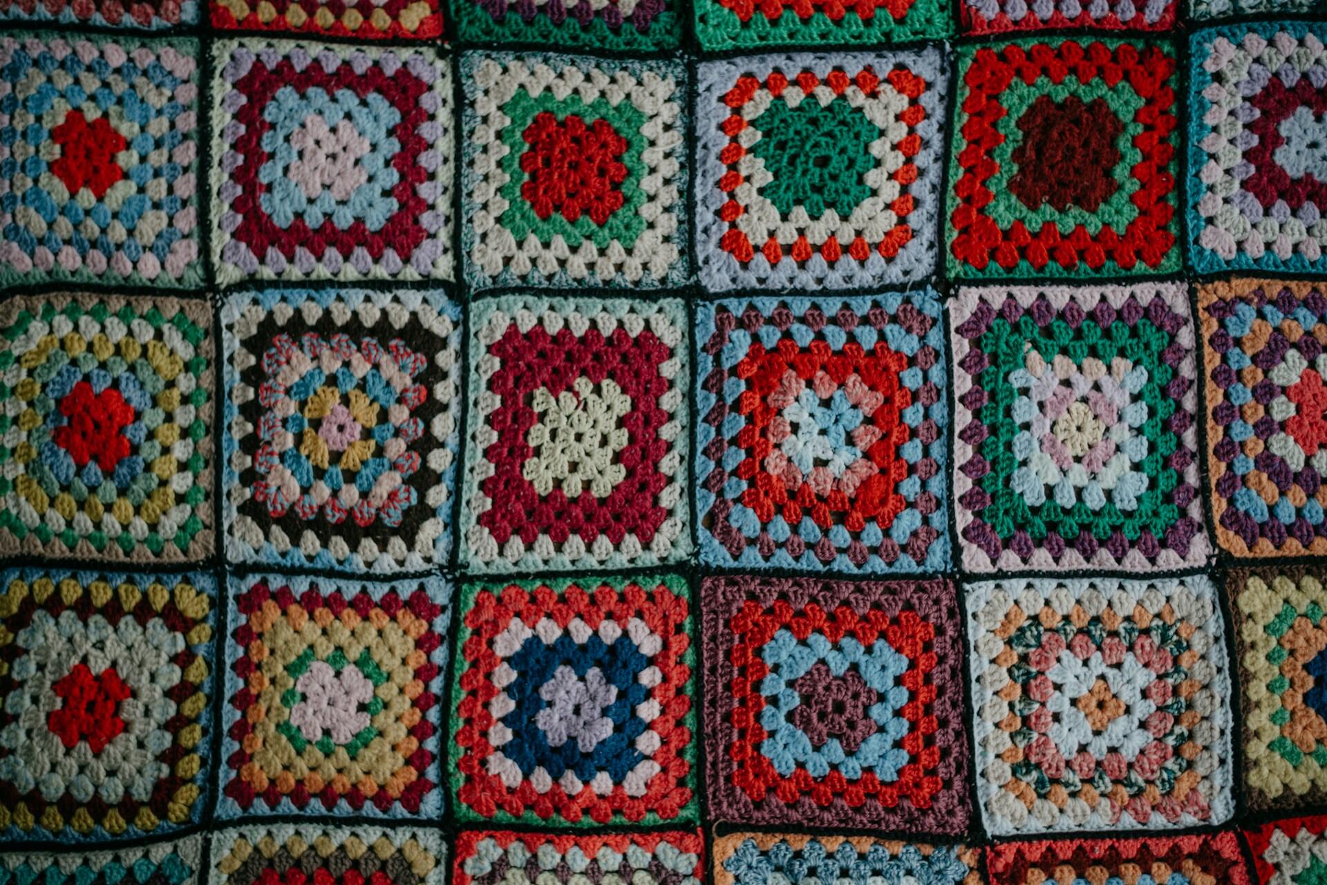 Colourful crocheted granny squares arranged in rows