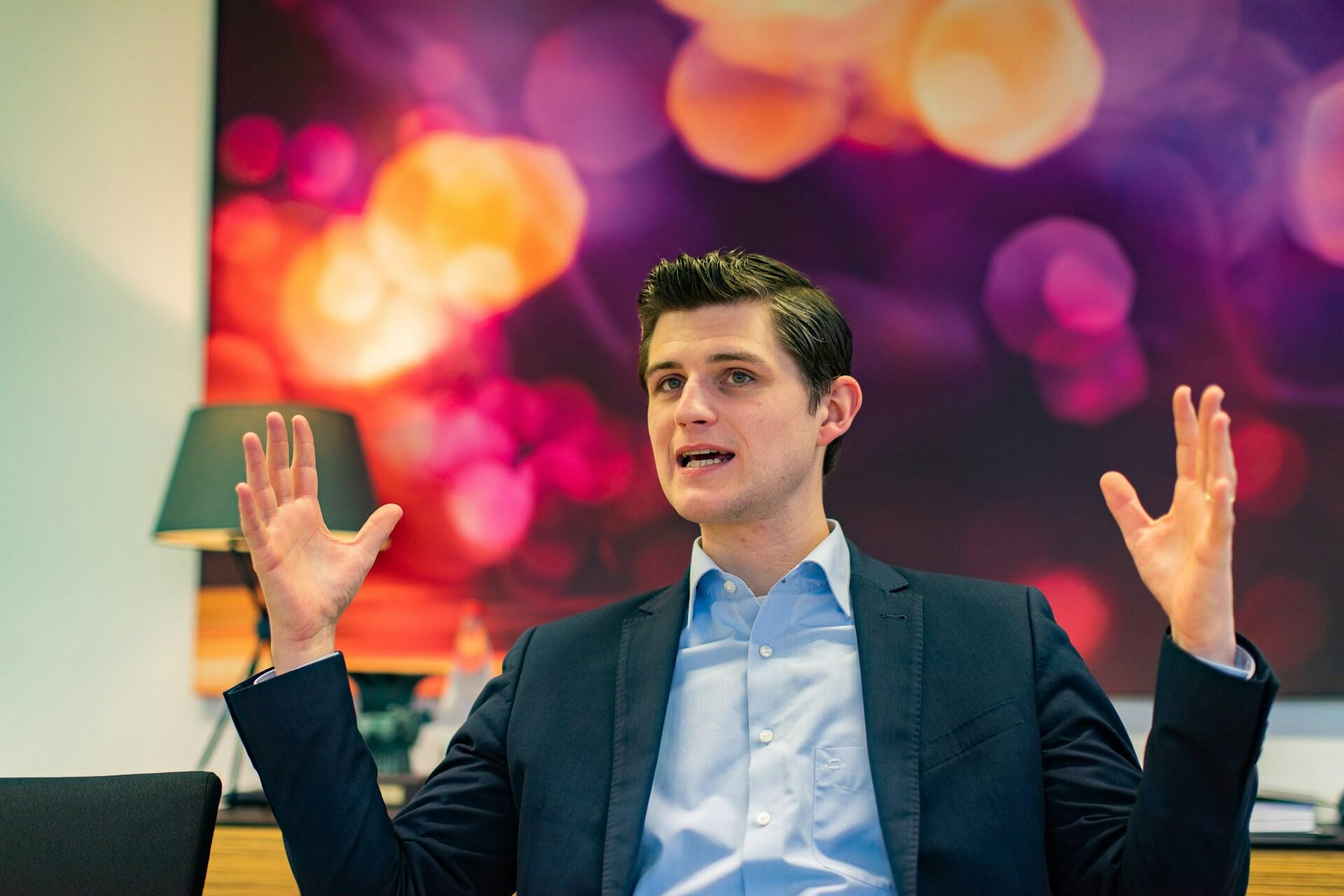Man speaking confidently while using hand gestures during a presentation