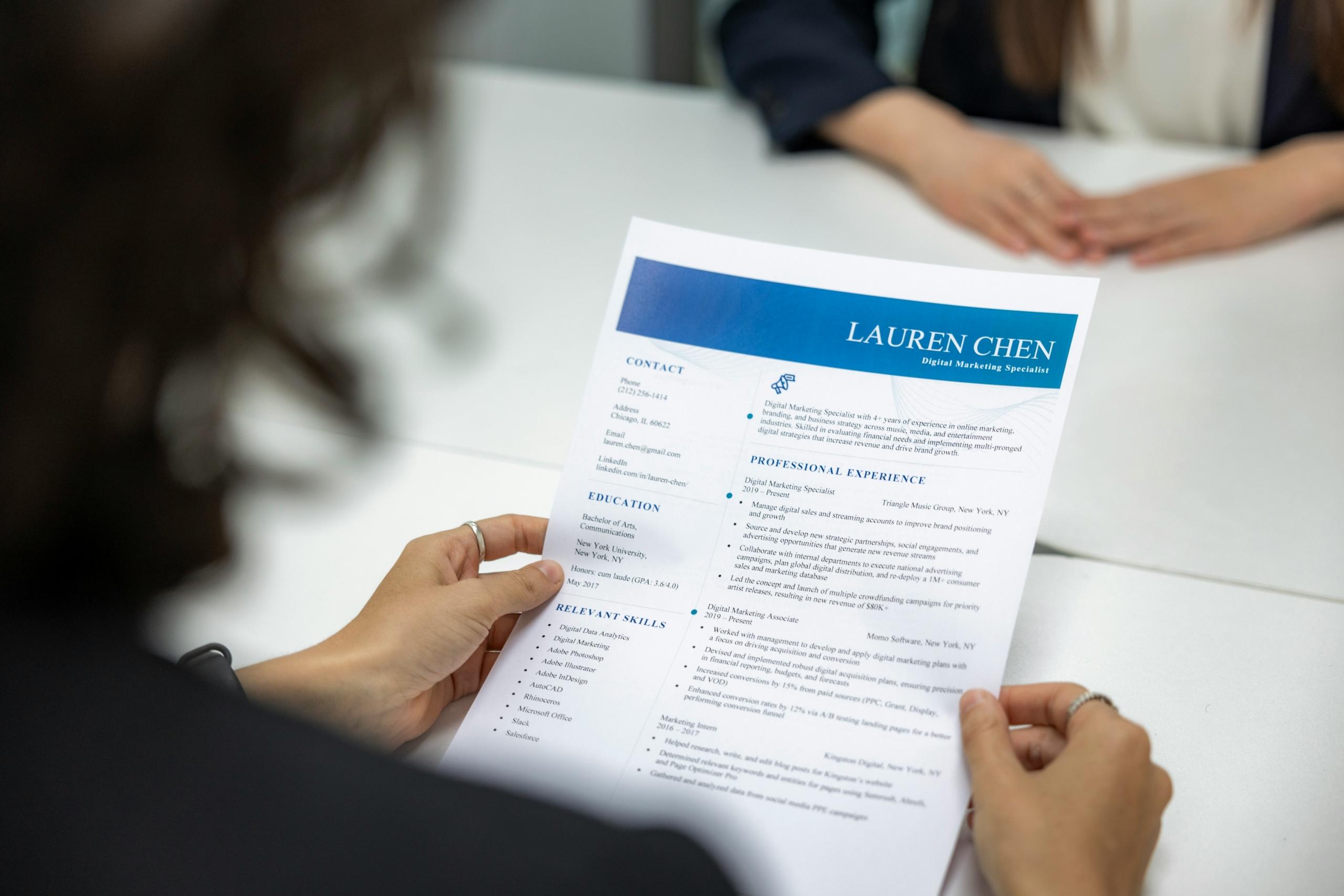 An employer carefully reviewing a CV that has been submitted by an applicant.