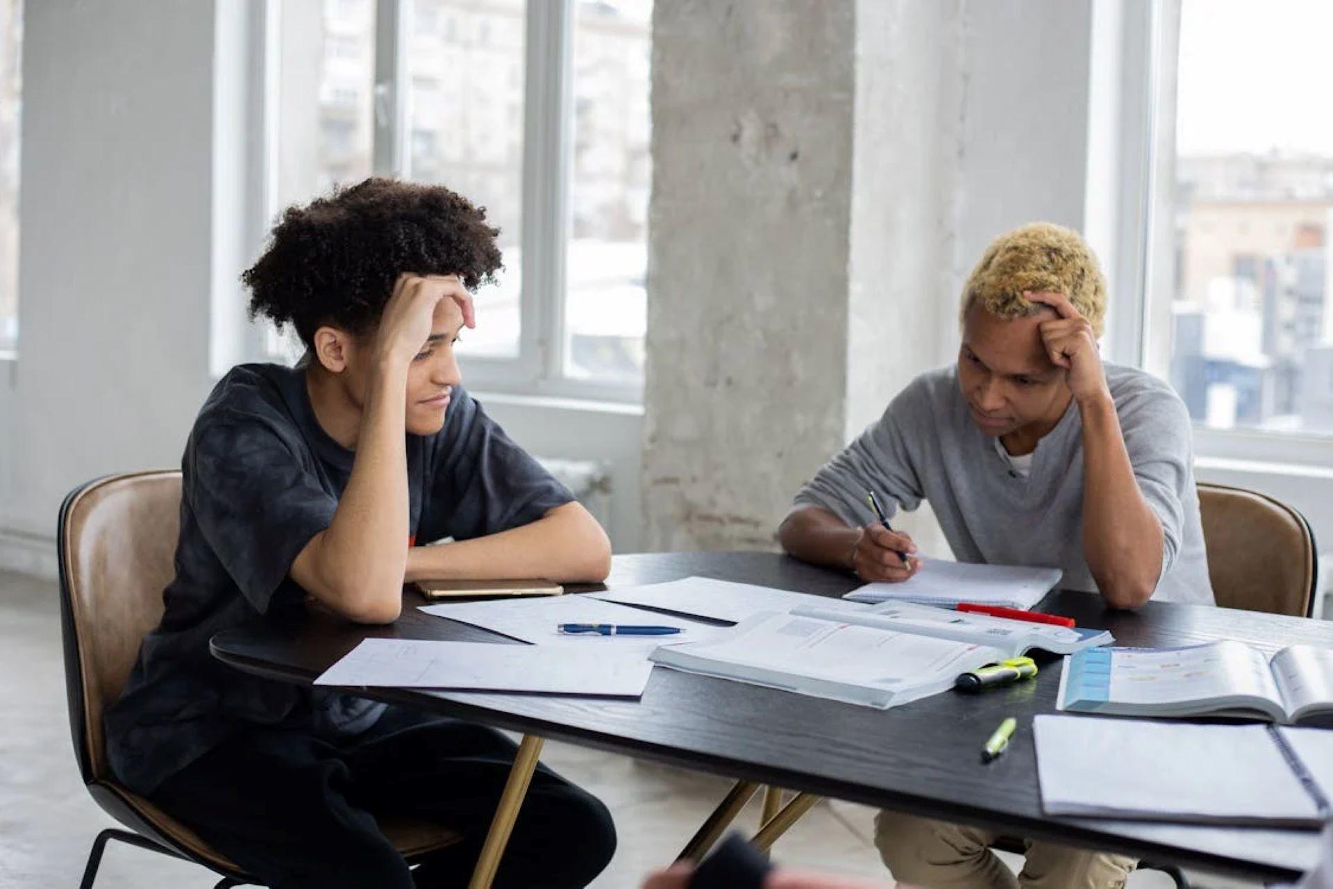Two students focused on studying at a table