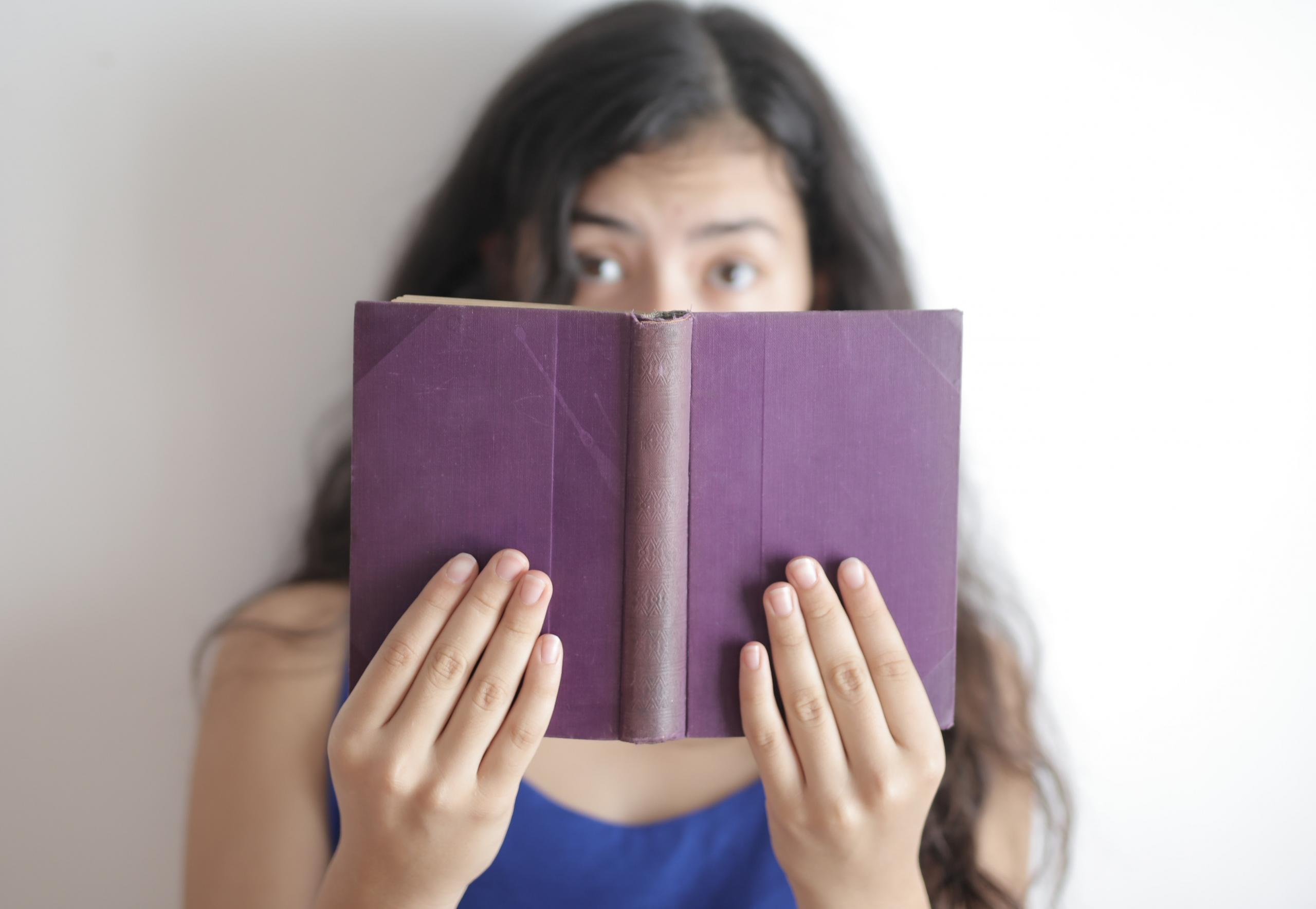 young girl with purple book