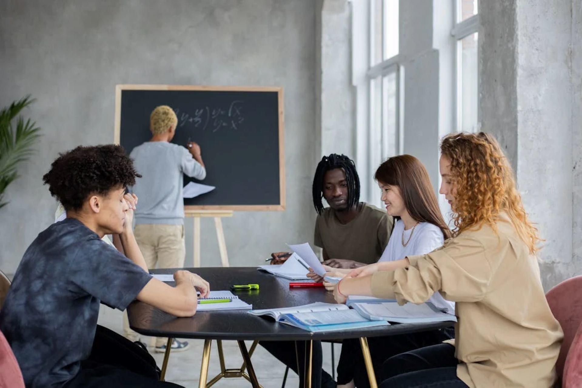 Students studying together with a teacher