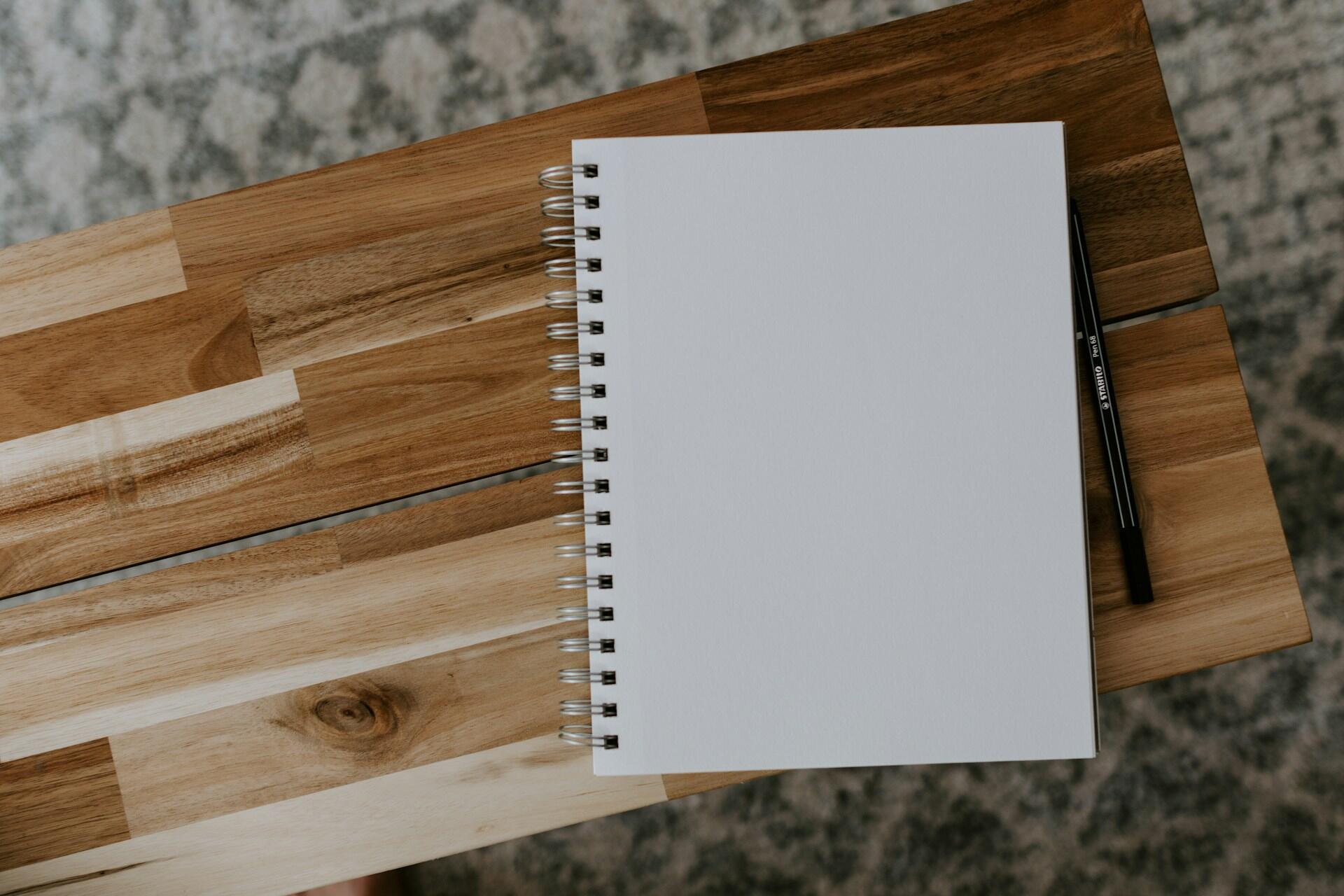 A notepad on a table or bench.