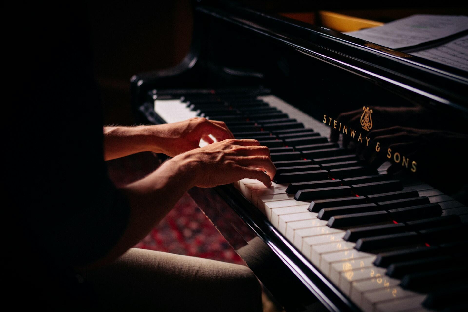 A pianist playing a Steinway.