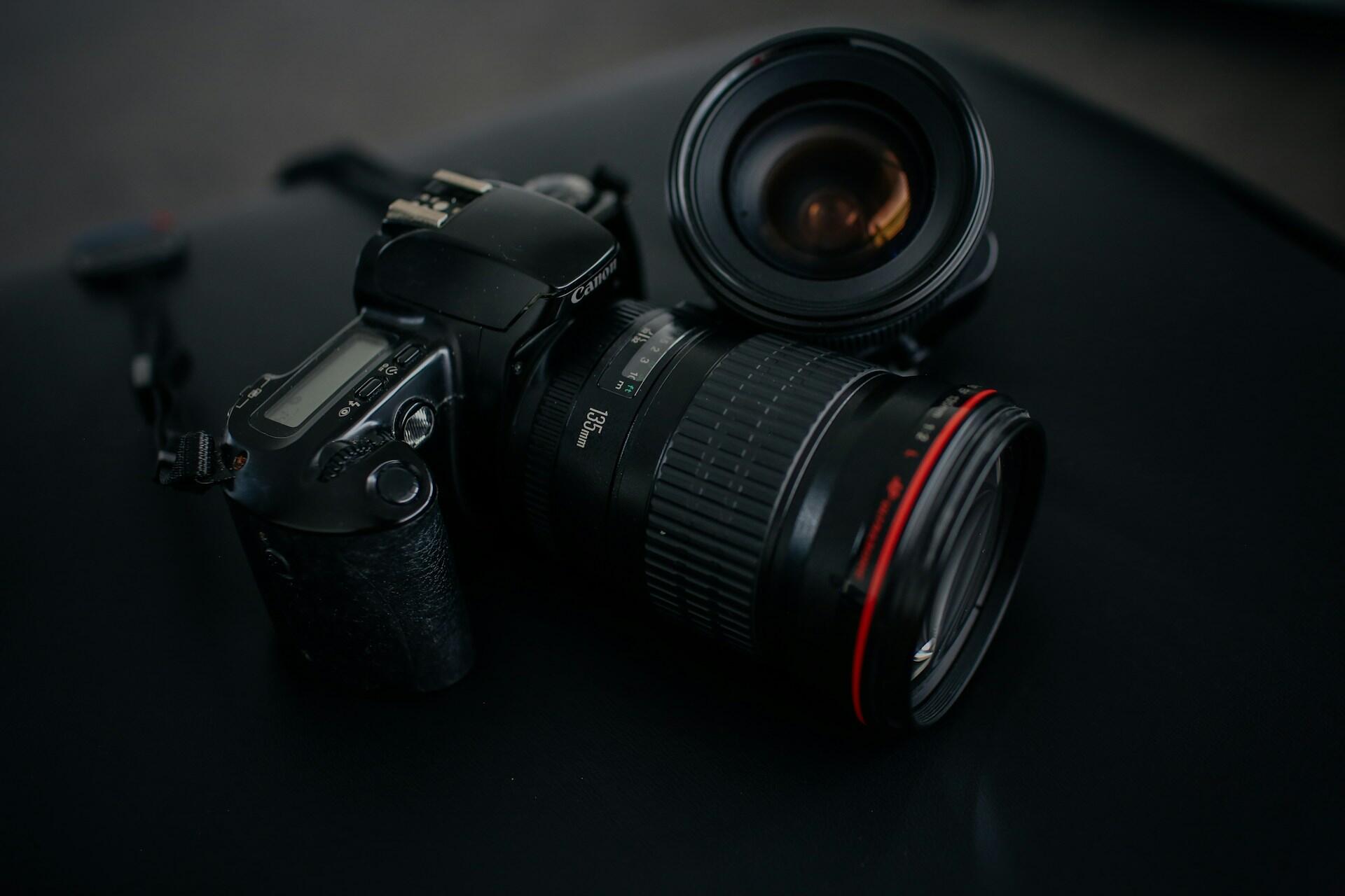 Canon camera body and lenses on a dark background