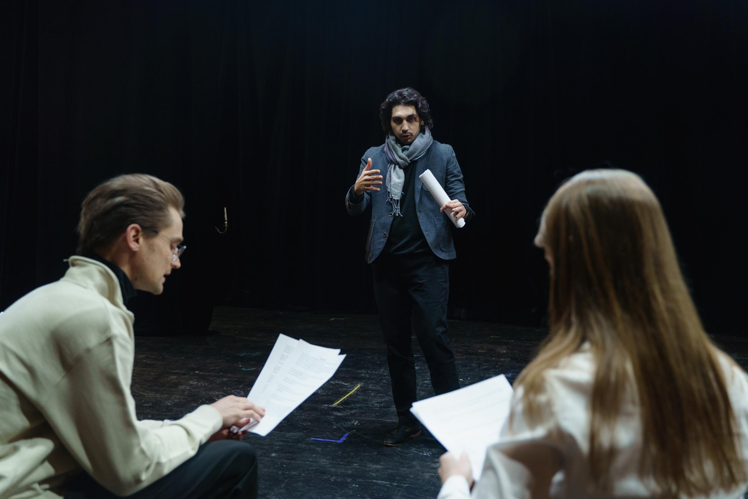 an actor reading his lines on stage
