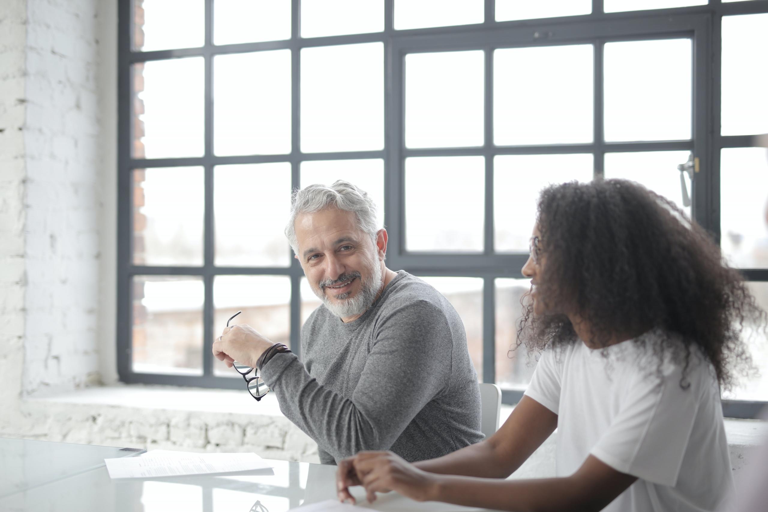 A coach giving career advice to one of his clients.