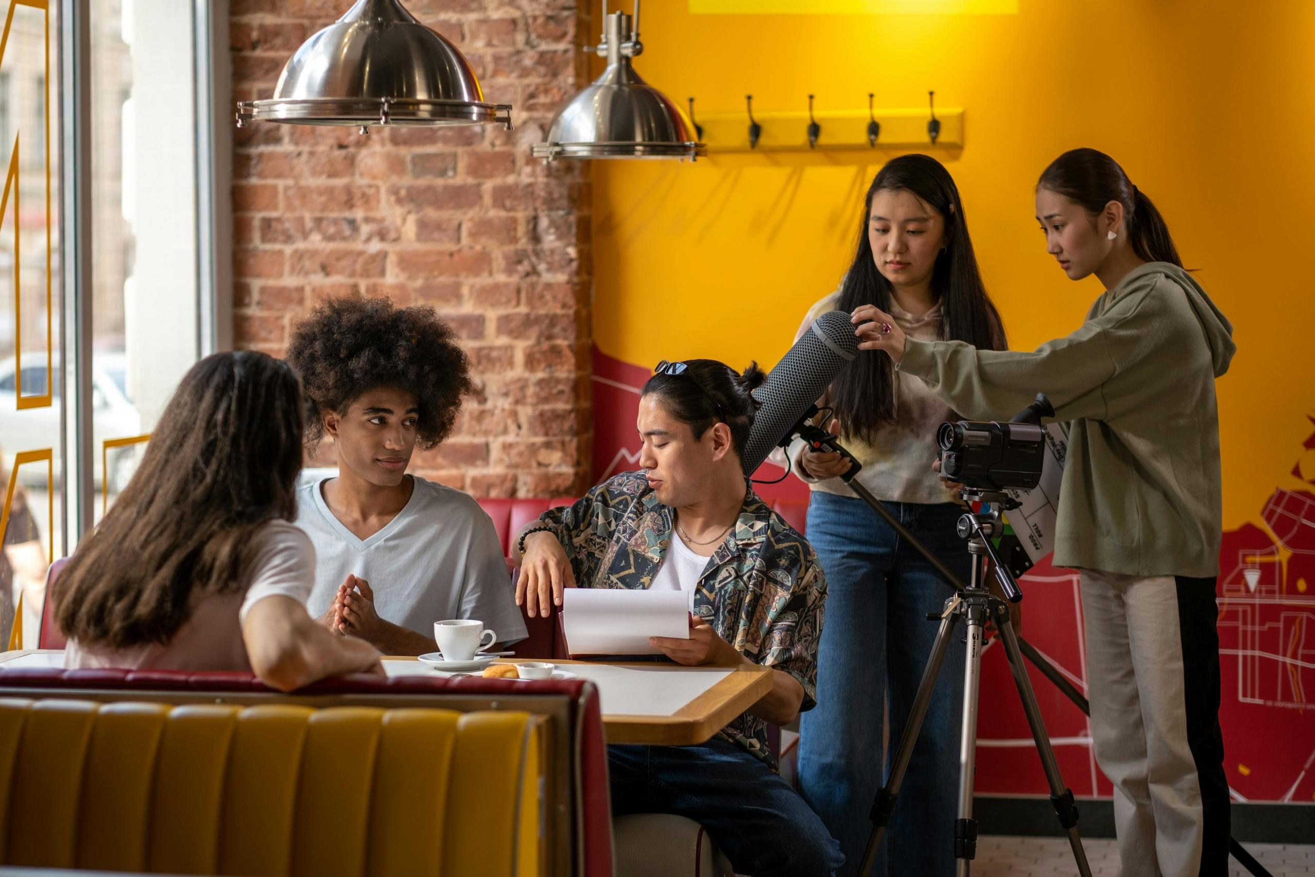 An action shot taken of some acting extras sitting next to the lead role in a movie.