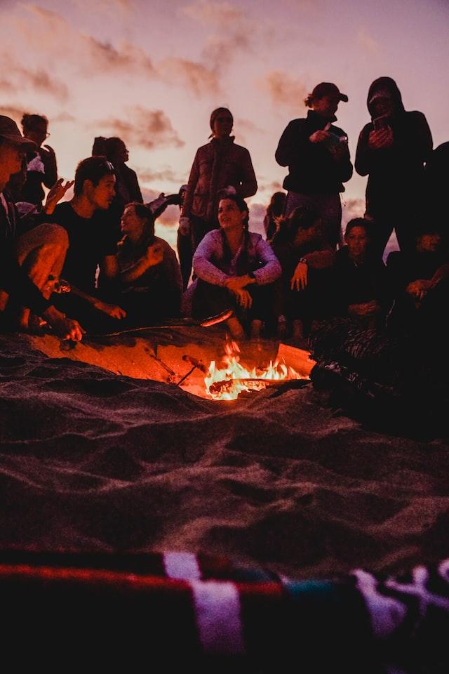 Young group of people gathered around a fire