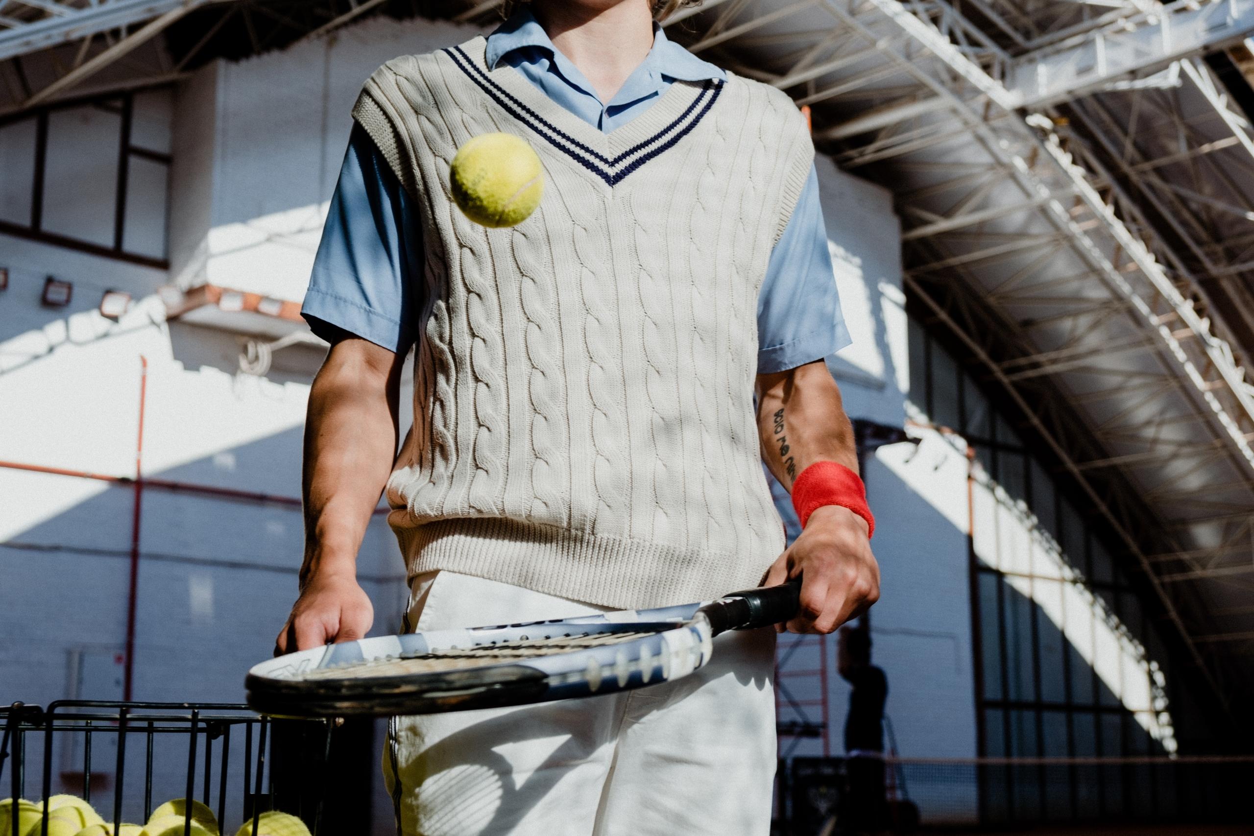 A tennis player hitting a tennis ball with his racket