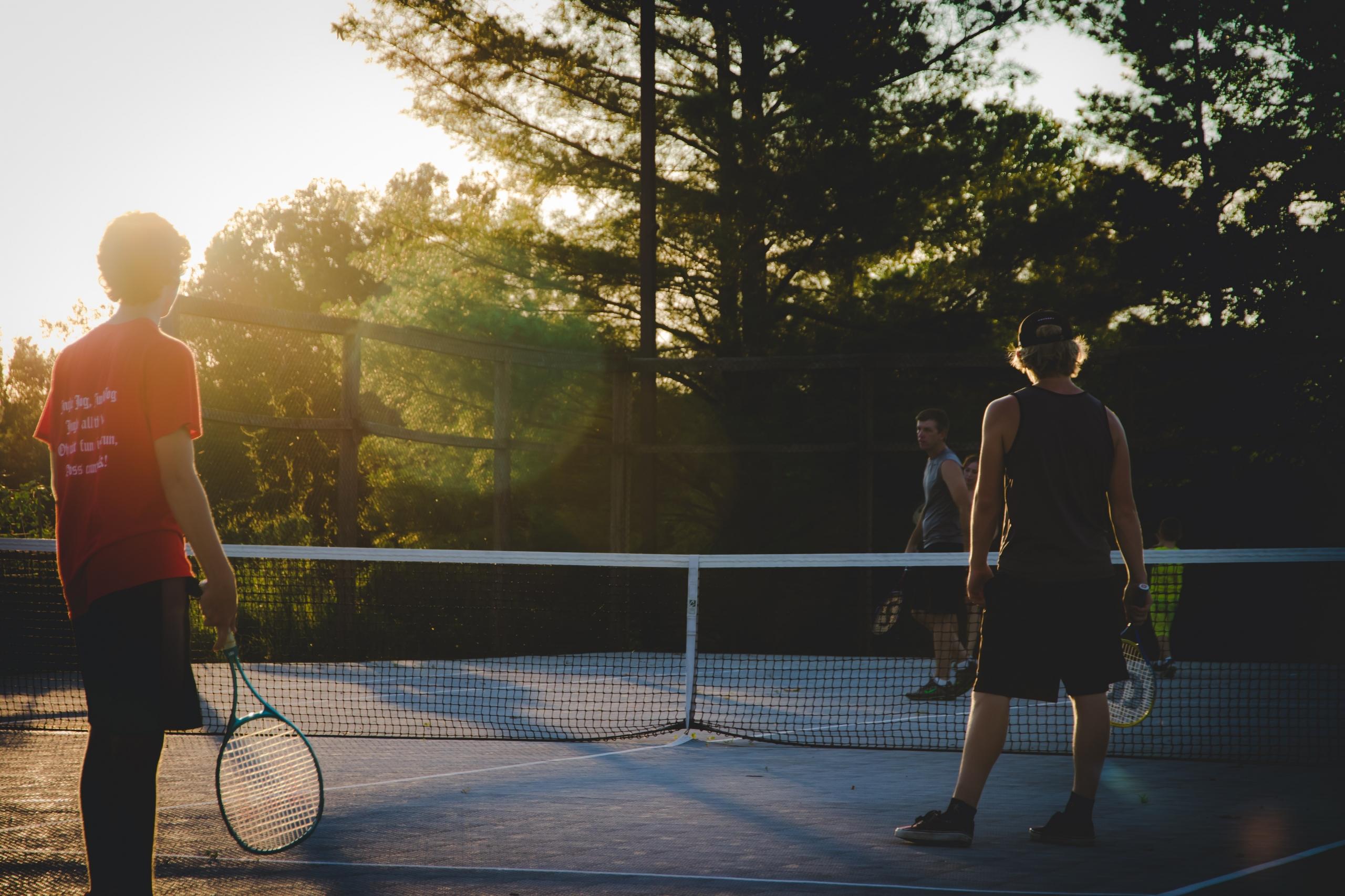 A tennis player learning from his tutor