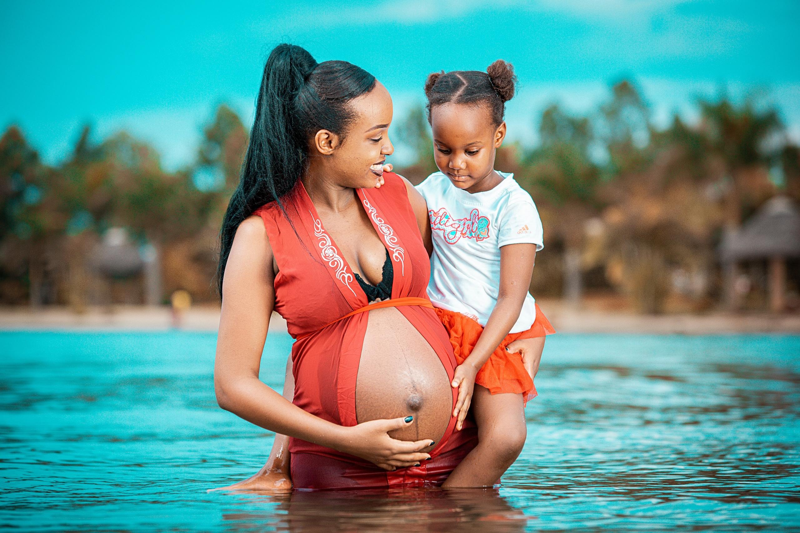 A glowing pregnant woman gracefully swimming in a serene pool, enjoying the soothing benefits of aquatic exercise during pregnancy