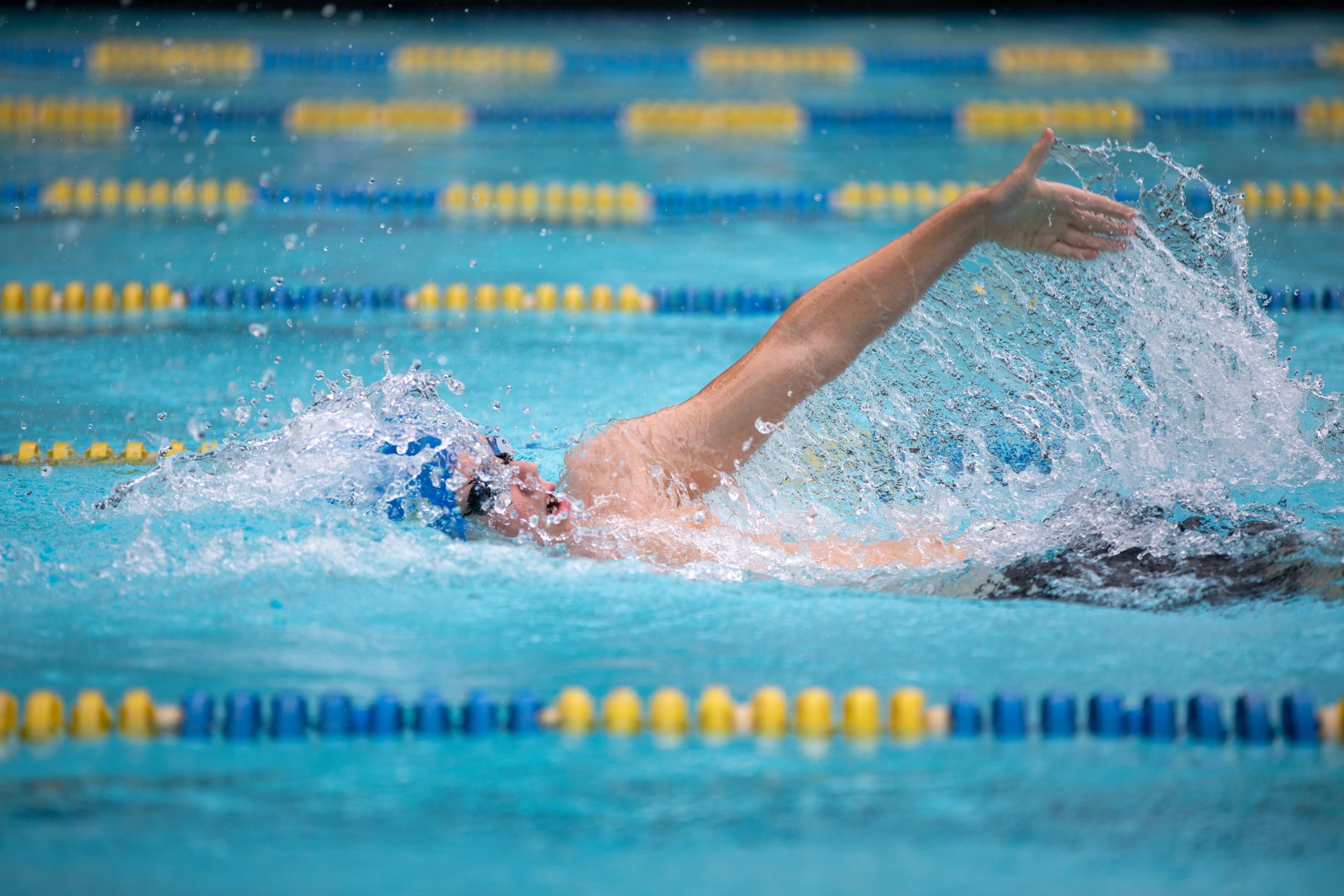 an experienced swimming tutor providing one-on-one instruction to a person with disabilities, making sure that baby swimming knows no bounds. Witness the sheer determination and confidence building within this inspiring aquatic session.