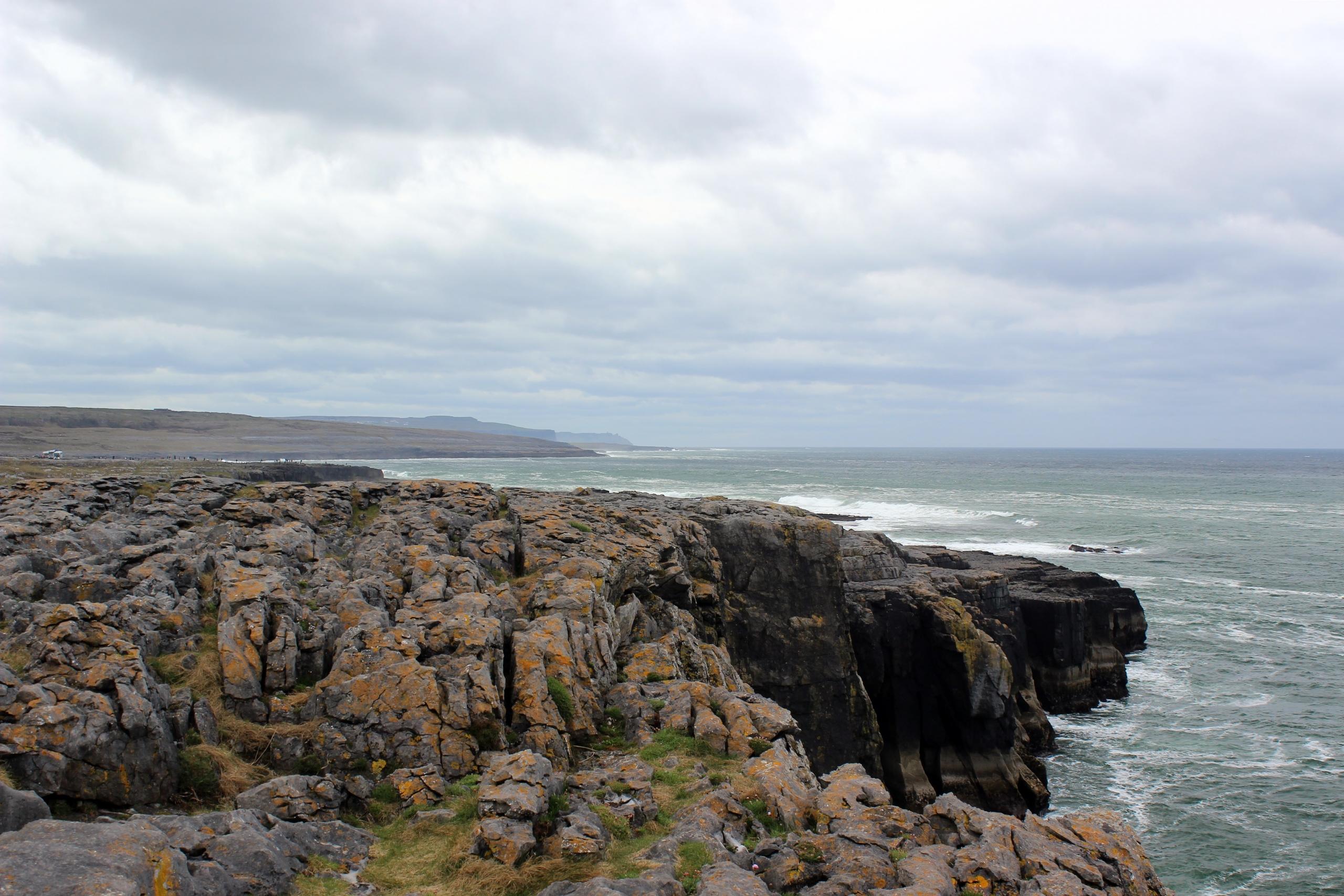 Breath-taking coastal panorama of an Irish beach, where families gather for a day of leisure and aquatic activities. swimming sessions add to the joyful atmosphere, as you splash in the gentle waves. Serene waters and sandy shores provide an idyllic backdrop for a delightful seaside experience.