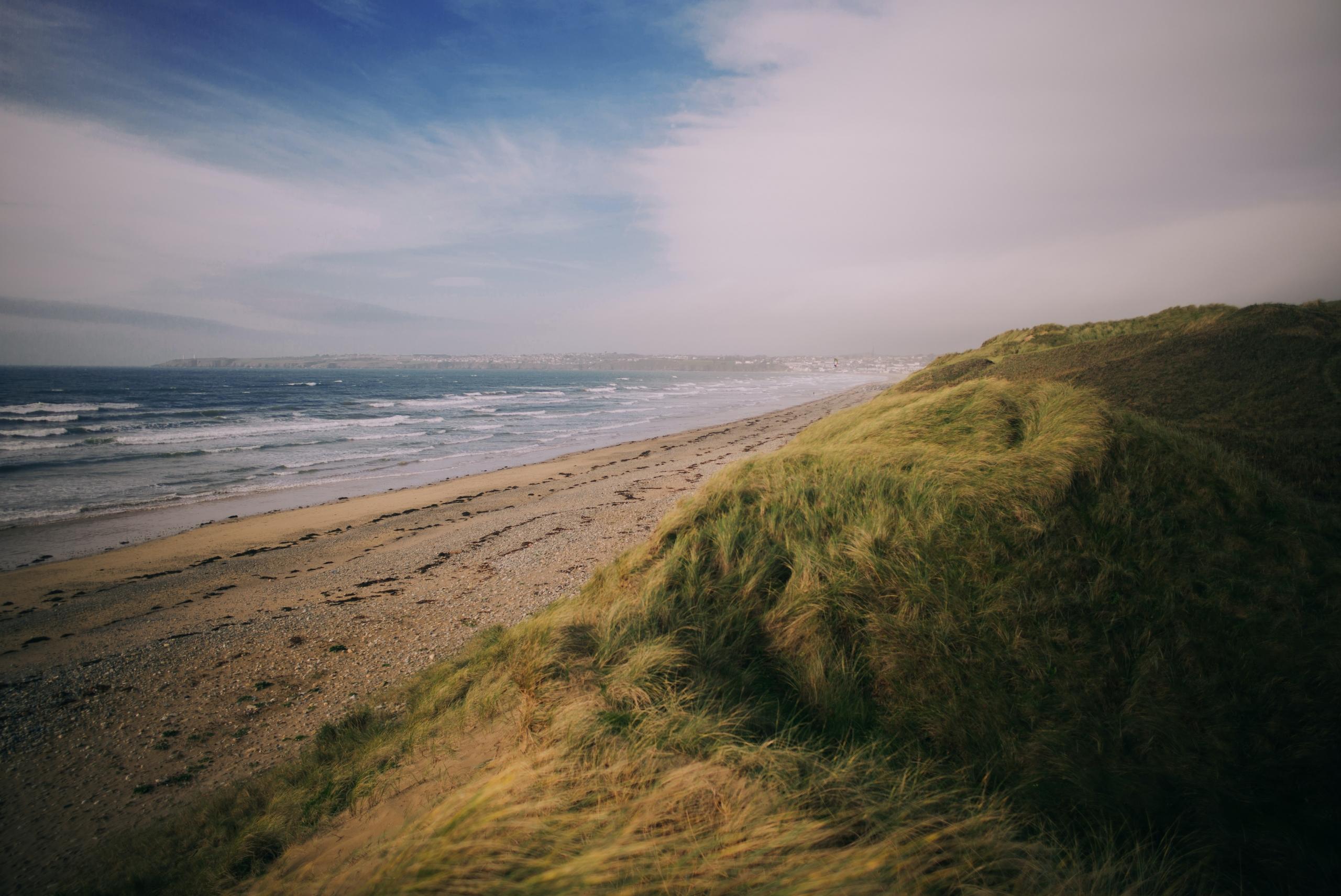 Scenic beach in Ireland, where families enjoy the sea and sun. Children's swimming lessons and baby swimming by the shore create delightful memories. Tranquil waves and sandy shores offer a perfect setting for aquatic fun and exploration.