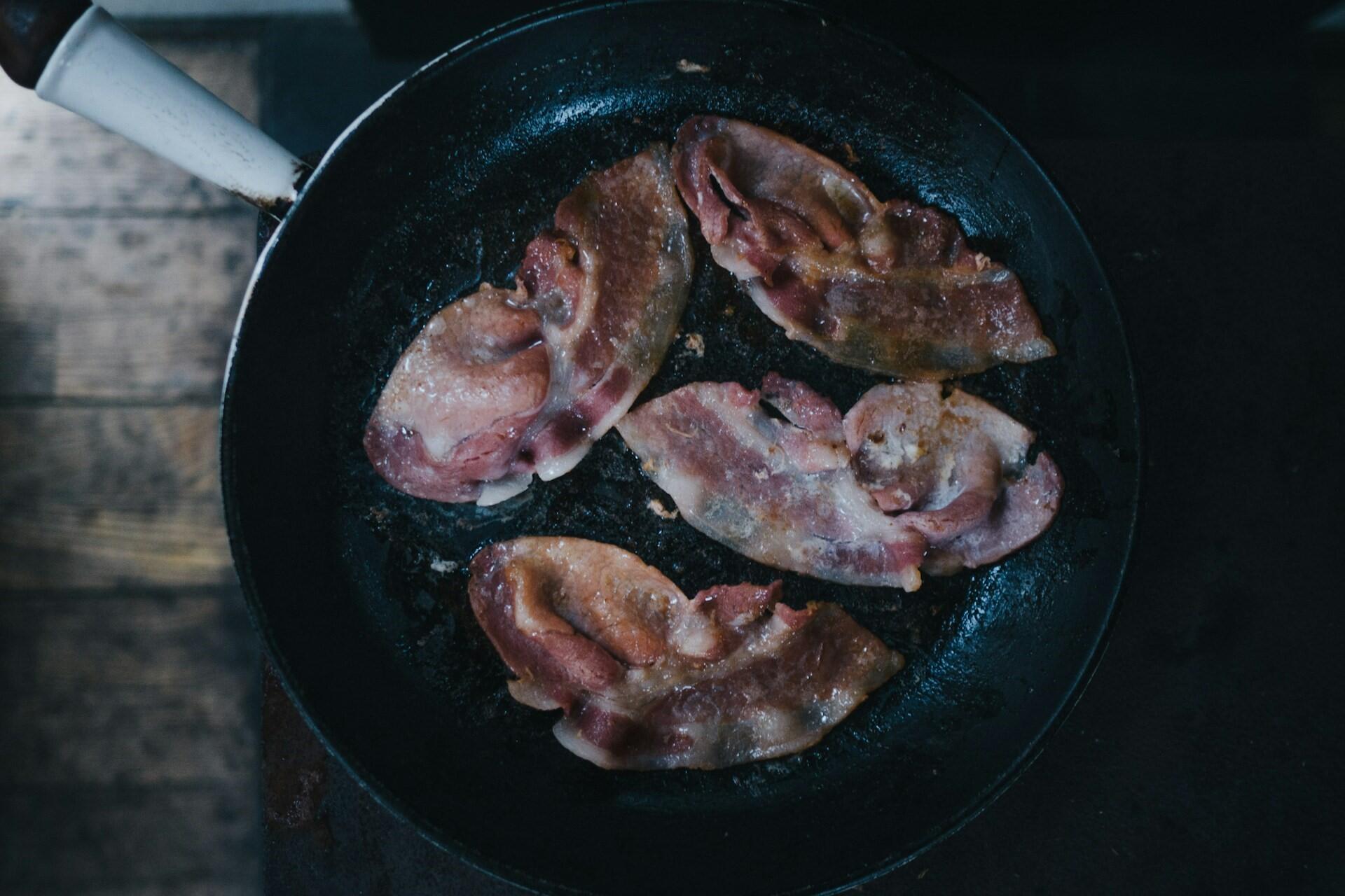 Bacon in a frying pan.