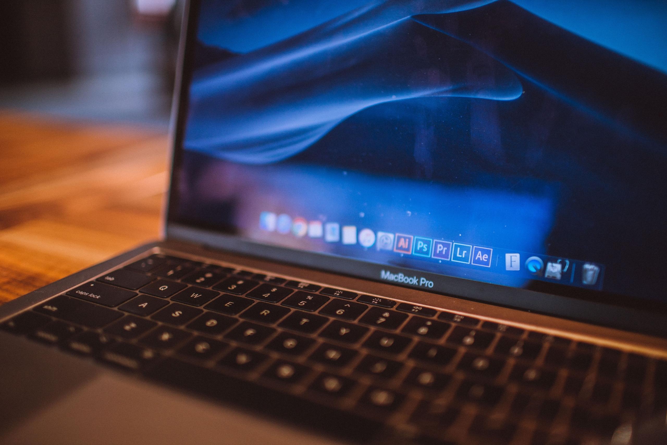 A laptop displaying a vibrant digital artwork.