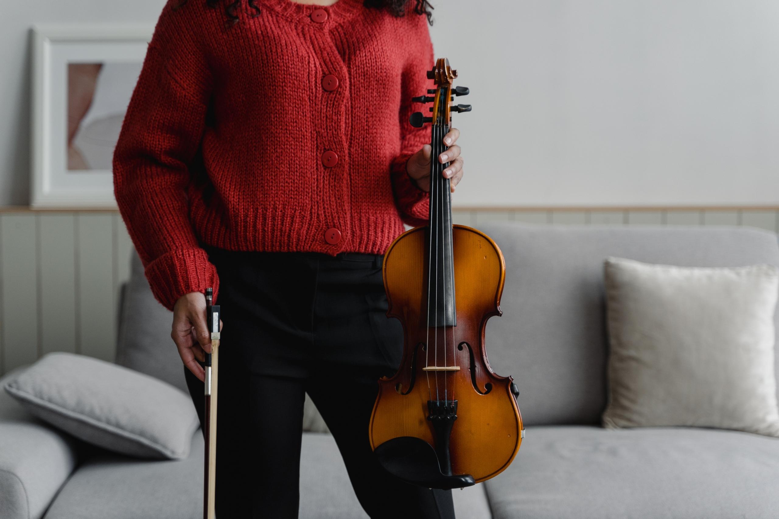 A captivating photograph revealing the timeless beauty of a vintage violin, emphasising the natural wood grain that adds character."