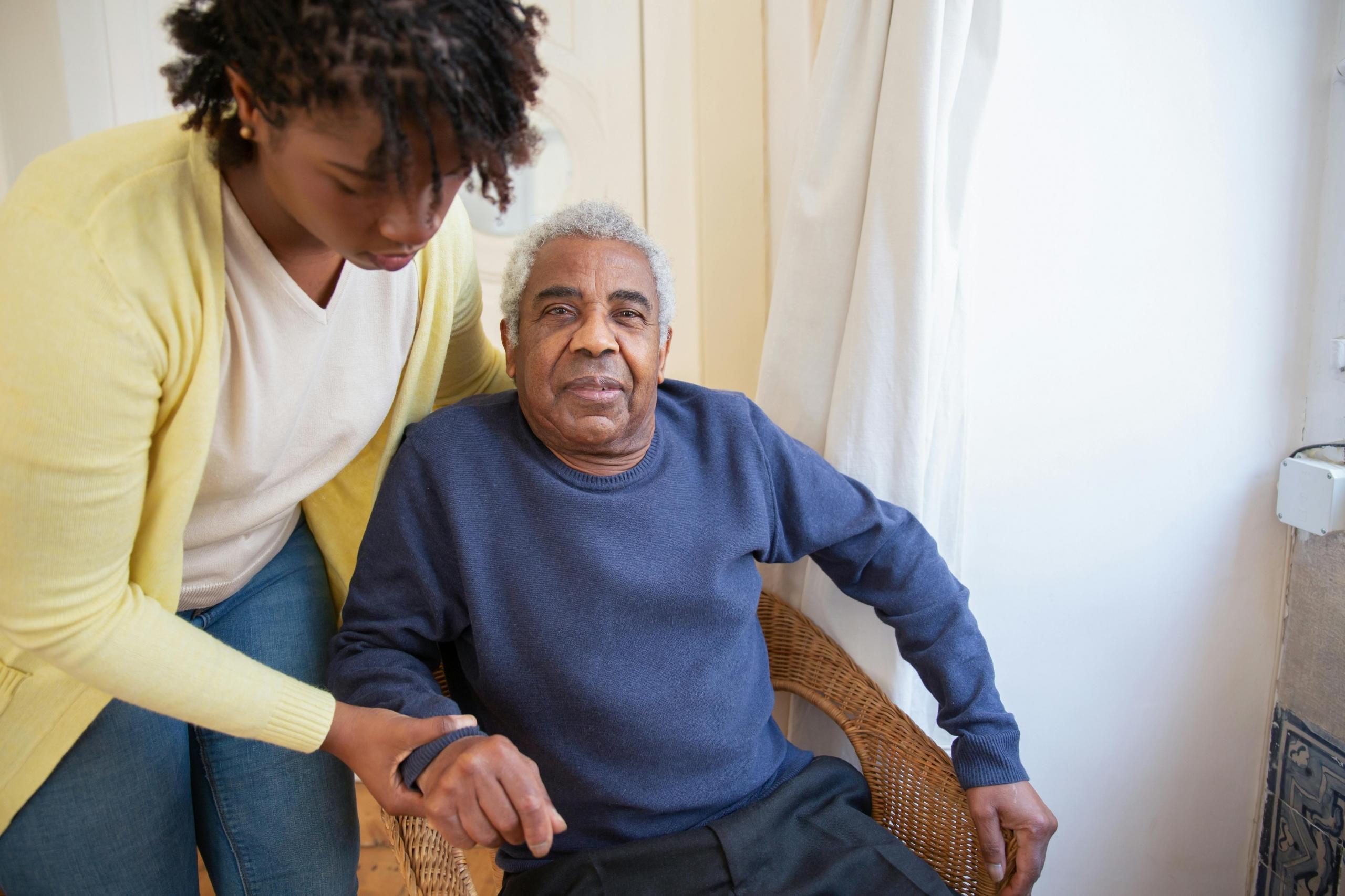 A nurse taking care of an elderly patient.