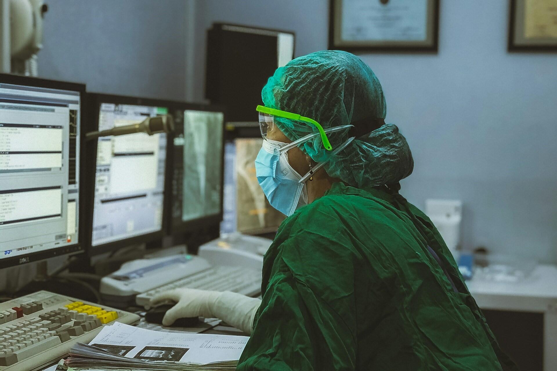 A nurse working on a computer.