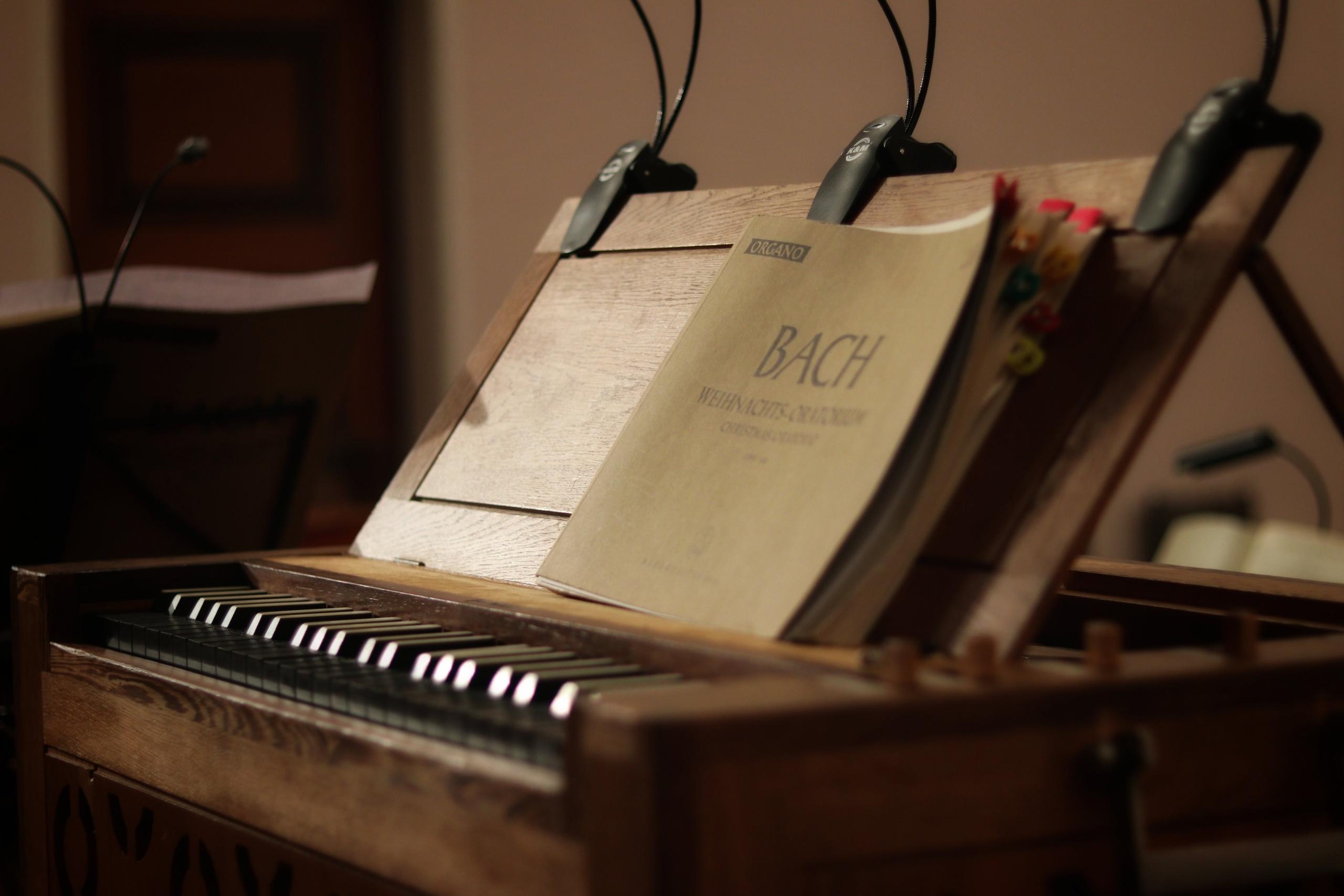 Bach music sheets resting on a piano.