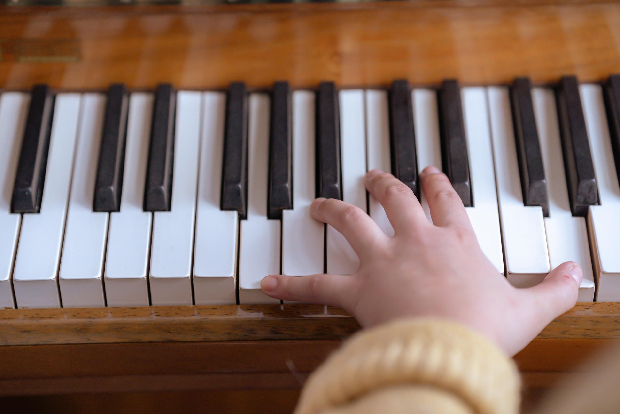 A student practicing the piano.