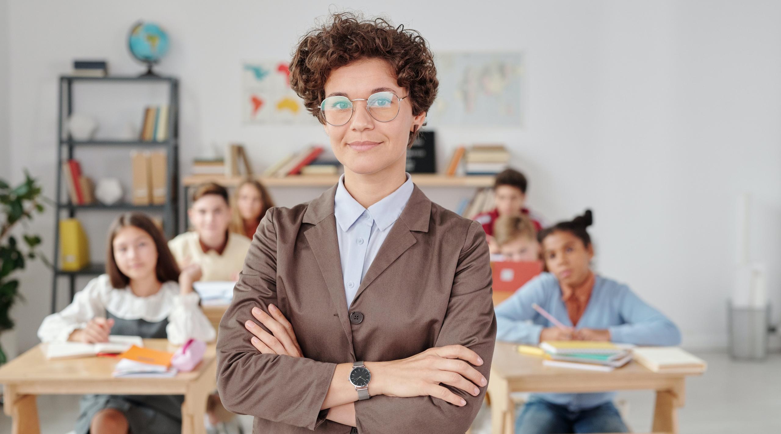A proud teacher standing in front of her class.