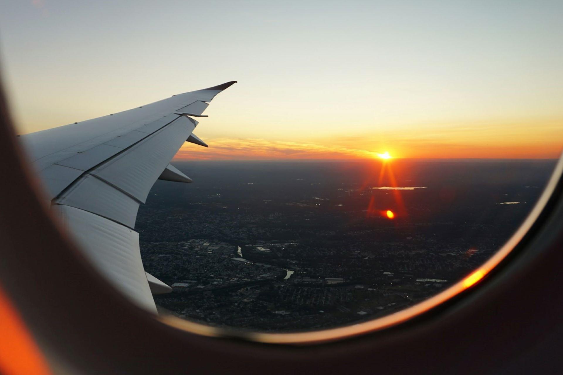 A view of a sunset from a plane window.