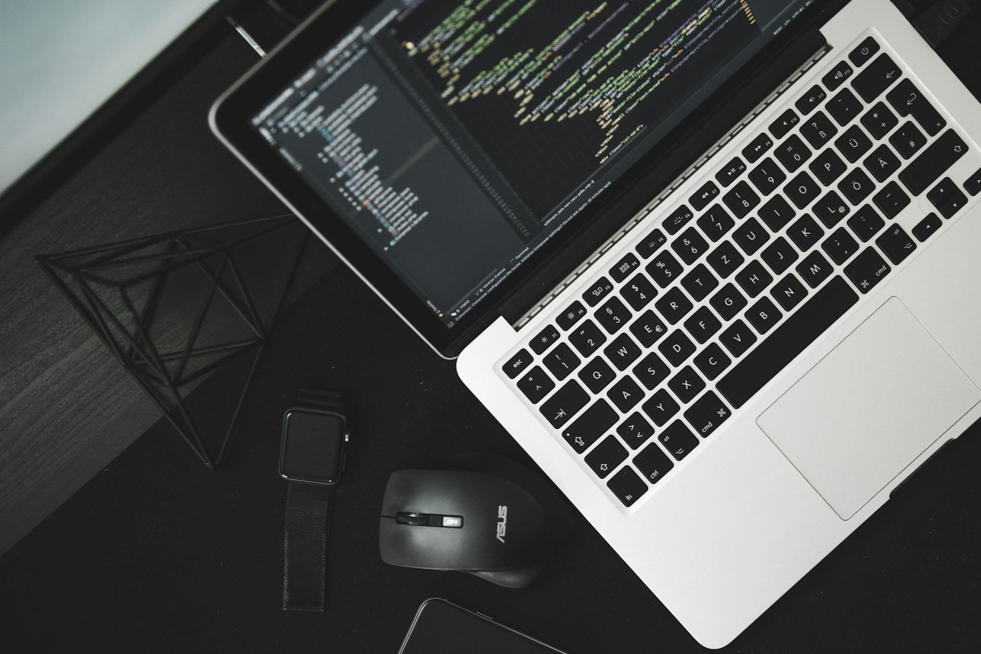 A laptop screen seen from above with lines of code on it.